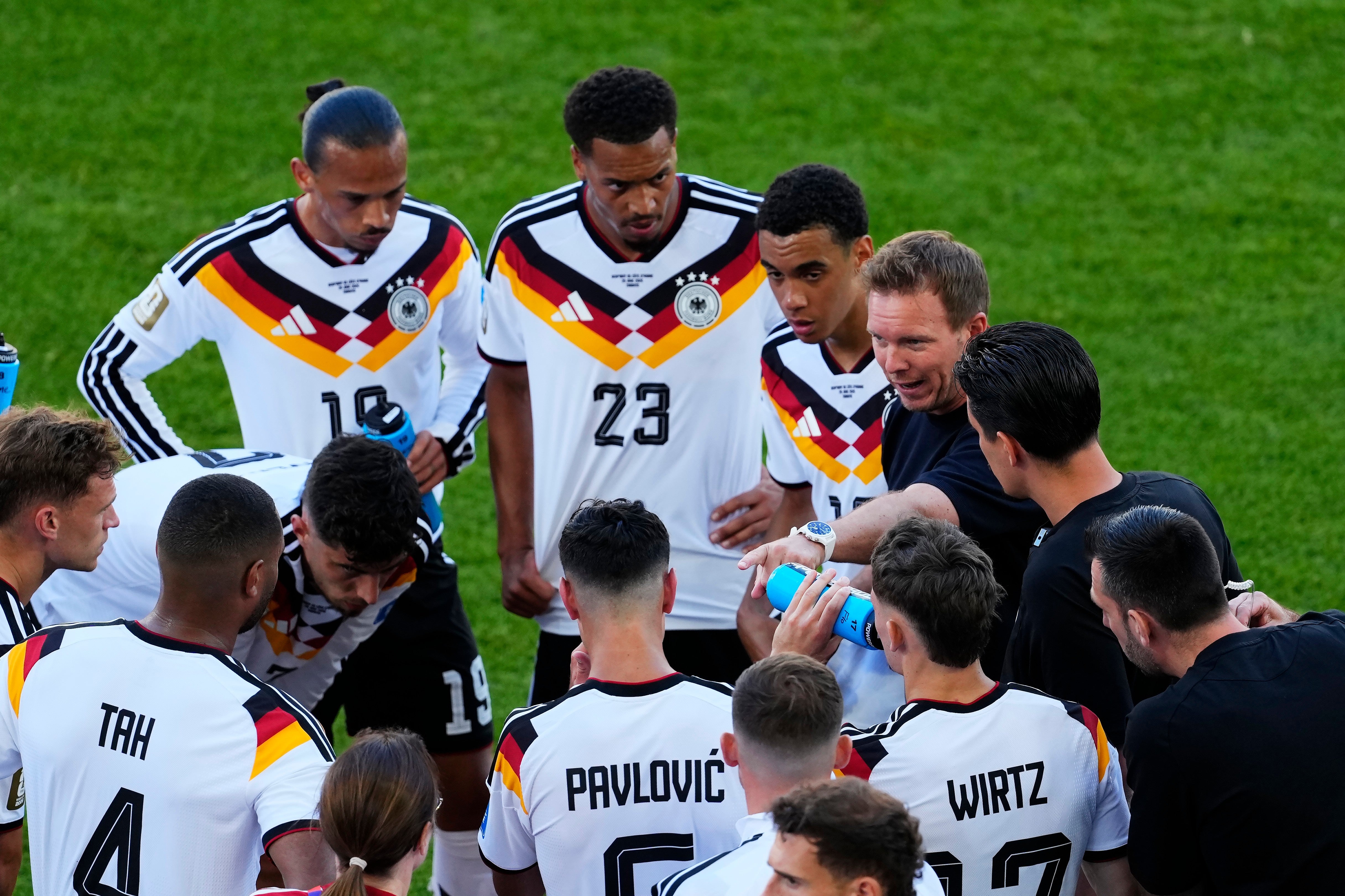 Julian Nagelsmann, right, speaks with his Germany team during the hydration break. (AP)