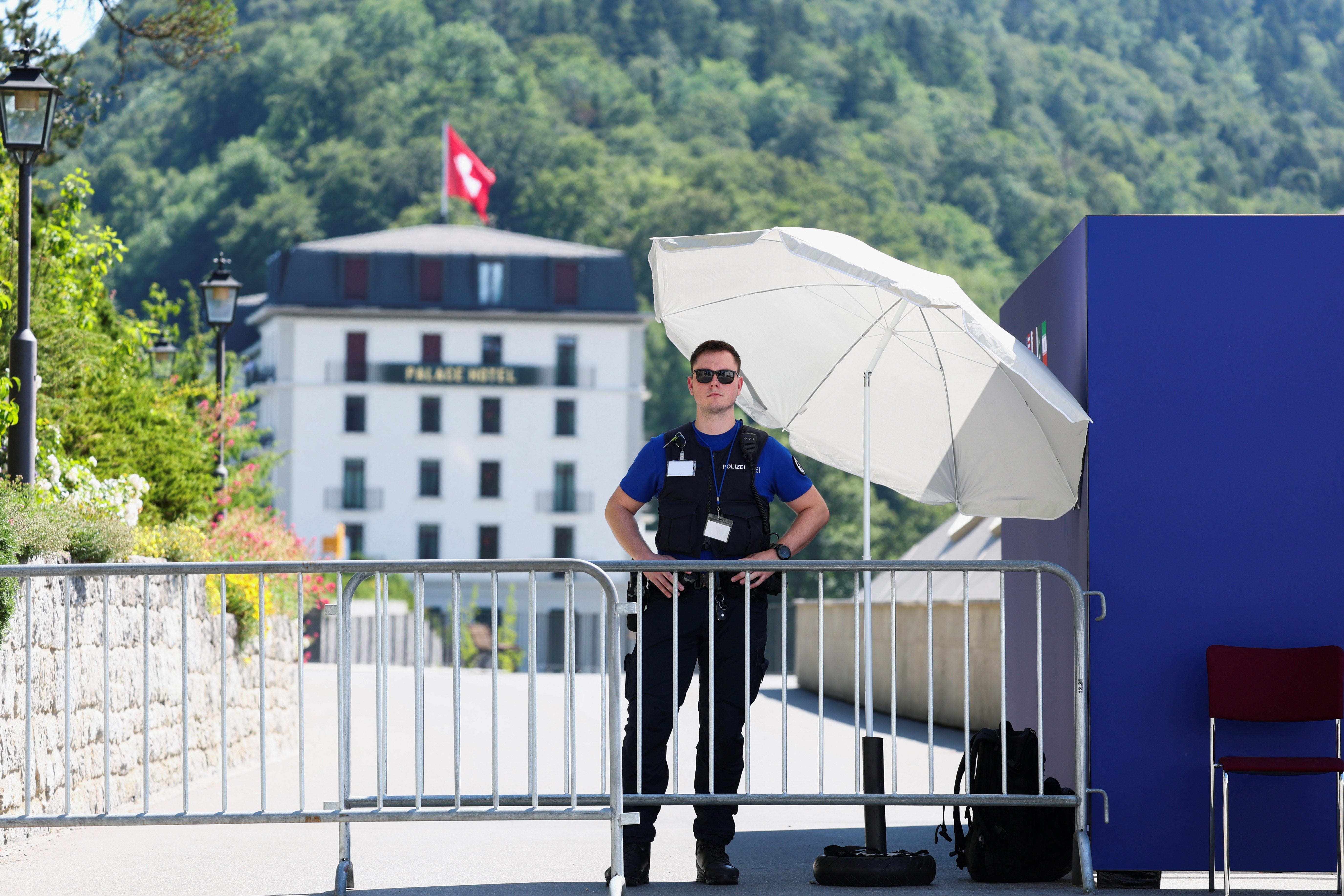 A police officer stands guard at one of the entrance to the Buergenstock Resort, on the day of US-Iran talks, in Stansstad, Switzerland, June 21, 2026 (Reuters)