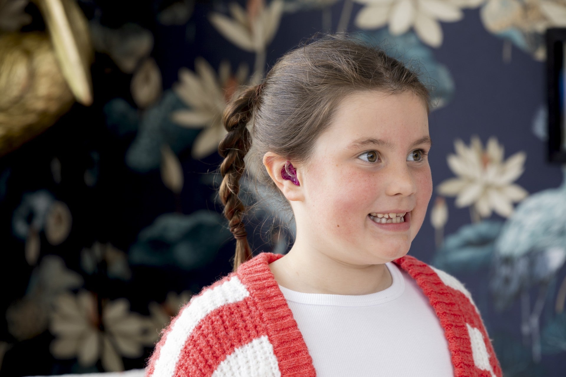Iona Fagerson, 7, pictured with her new hearing aid (The Hearing Clinic UK/Martin Shields/PA)