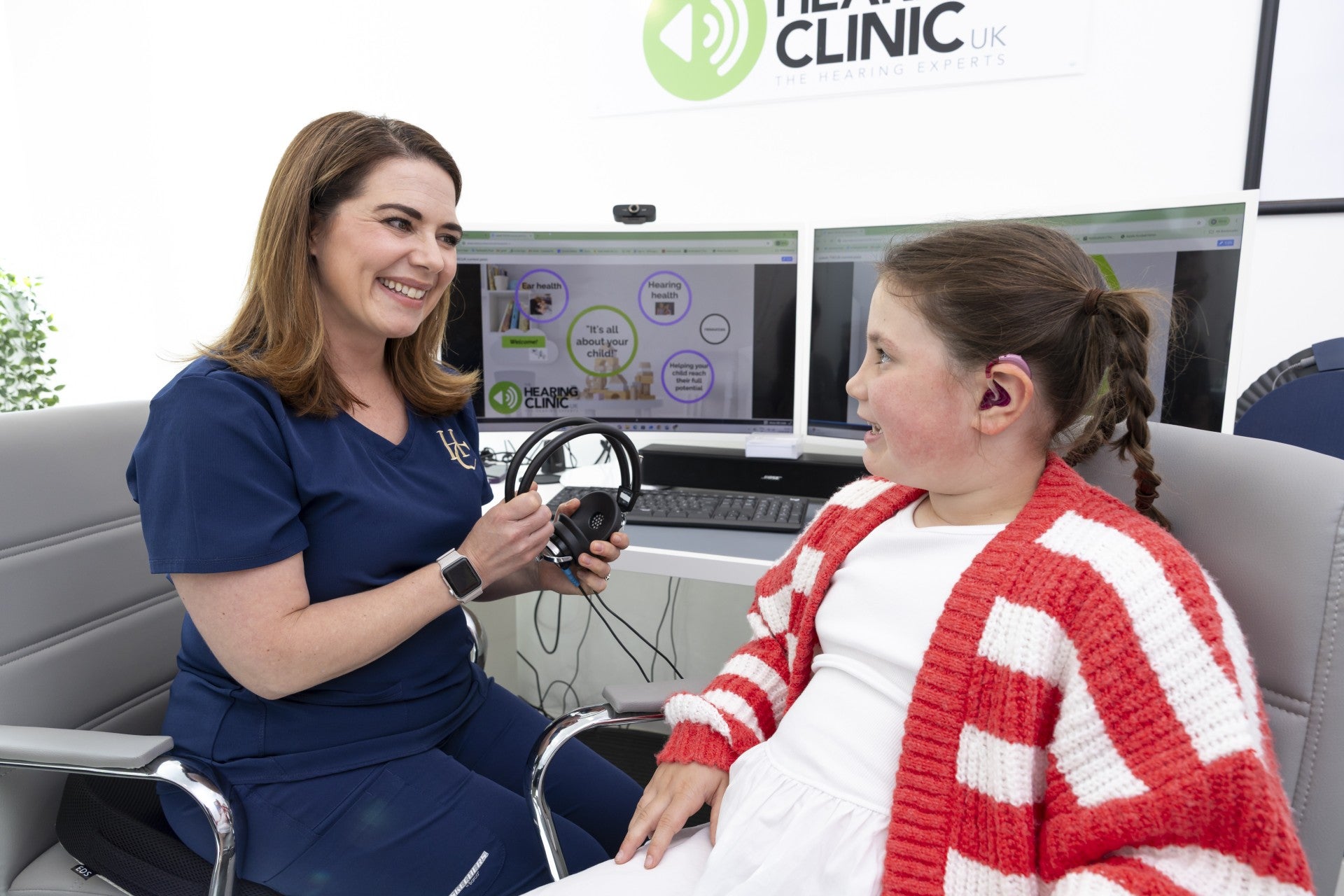 Iona Fagerson, 7, pictured with senior audiologist Dominique Stone at The Hearing Clinic UK’s clinic in Milngavie (The Hearing Clinic UK/Martin Shields/PA)