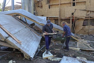 Employees remove debris at a compound of an agricultural enterprise hit by a Russian missile strike on Sunday evening, amid Russia's attack on Ukraine, in Odesa region, Ukraine 22 June 2026