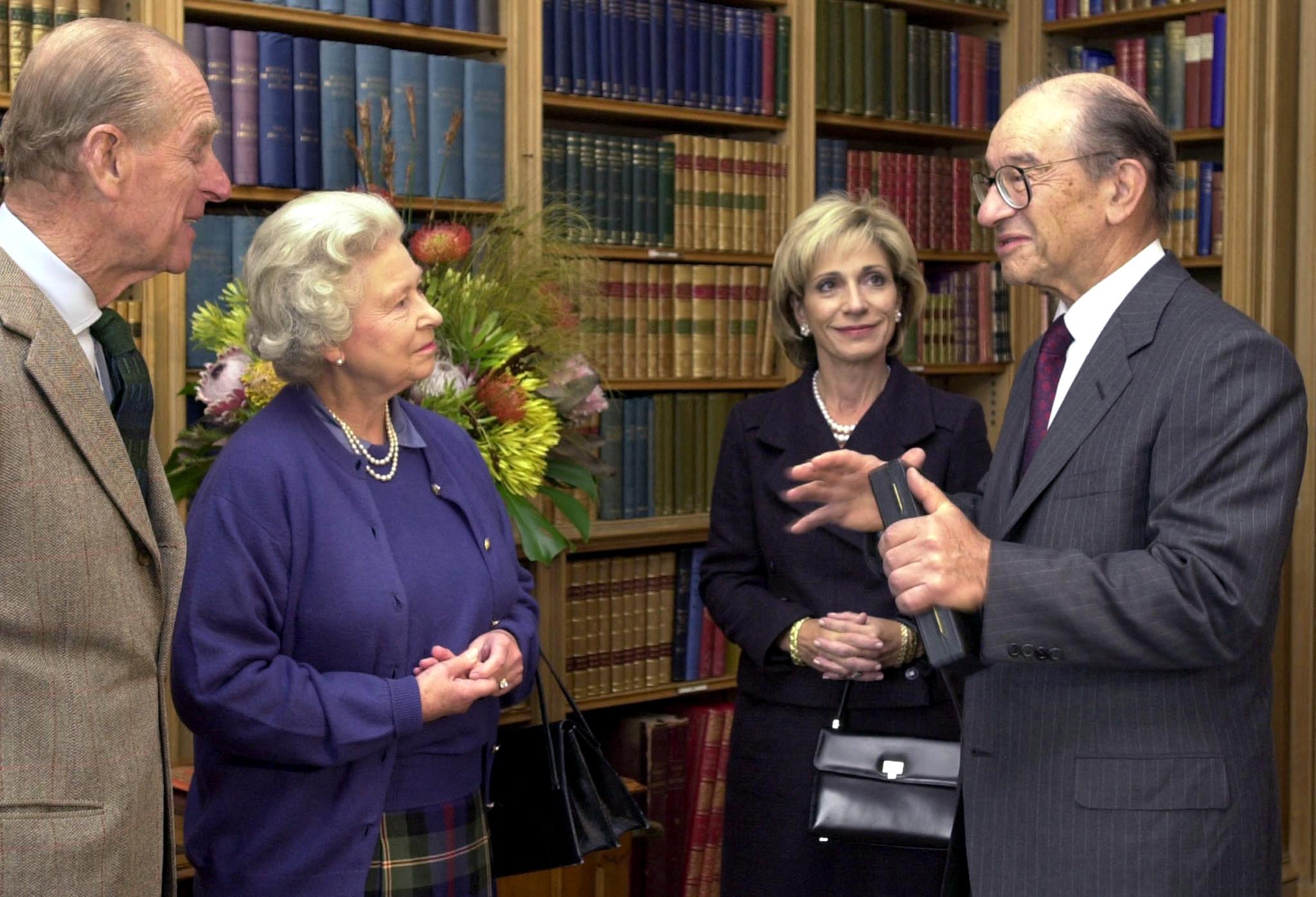 Greenspan (R) collects his honorary knighthood from Queen Elizabeth II (2nd L) with his wife Andrea Mitchell at his side and the Duke of Edinburgh (L) at Balmoral castle in the Scottish Highlands in 2002 (AFP/Getty)