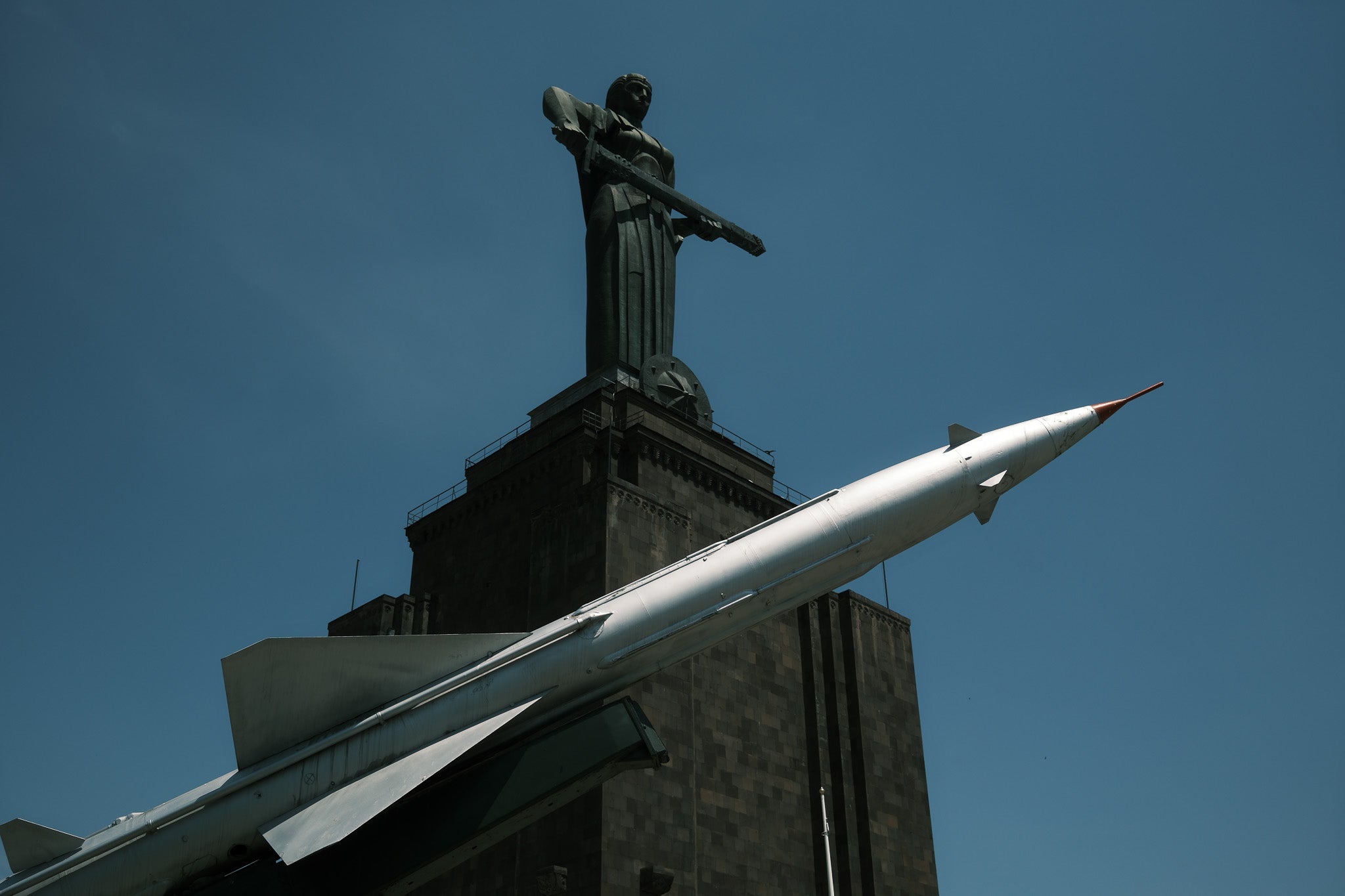 Mother Armenia overlooks the city of Yerevan surrounded by old tanks and missiles