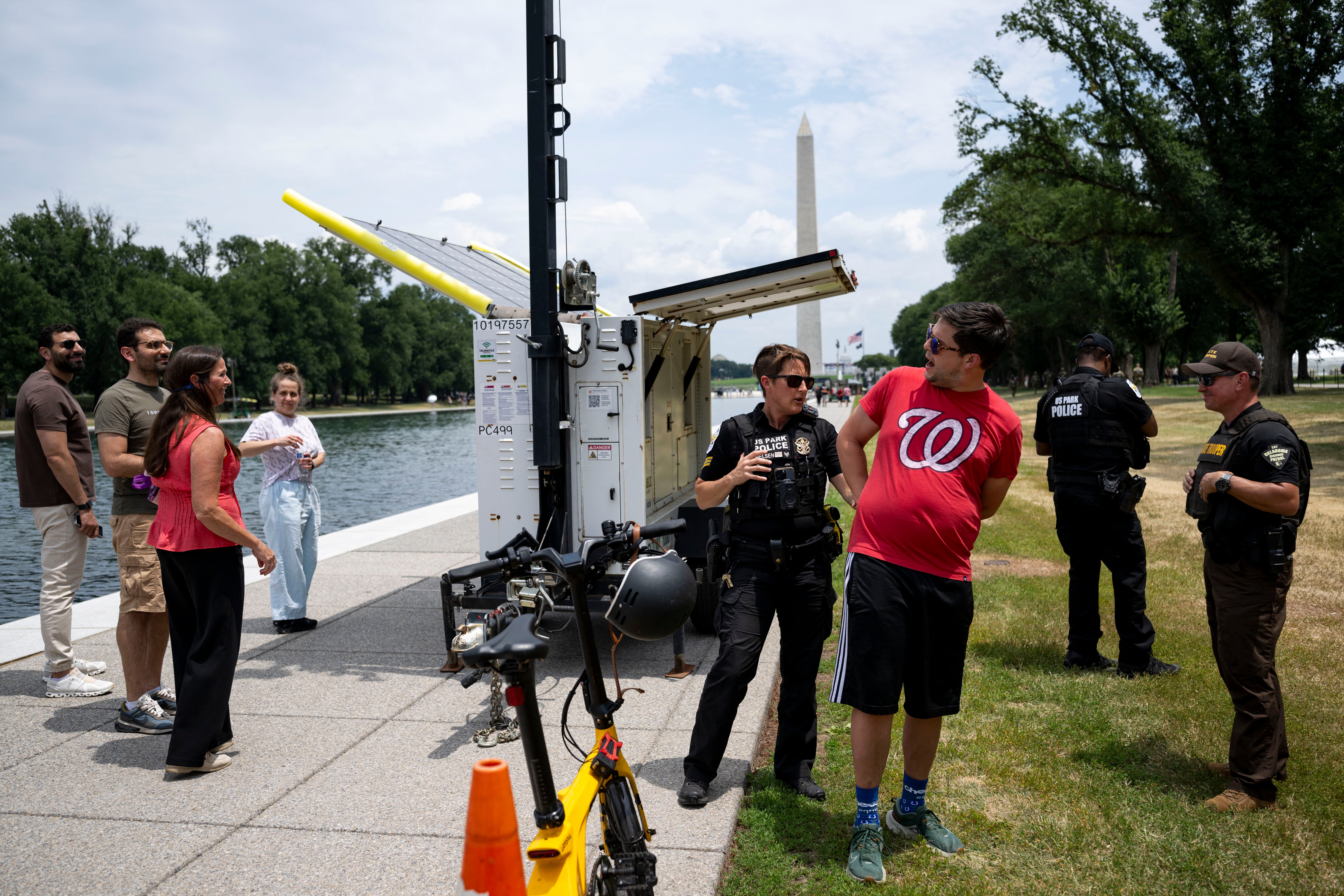 A man is arrested after shouting at police patrolling the Lincoln Memorial Reflecting Pool on Monday. The scene has become a fixture for D.C. residents