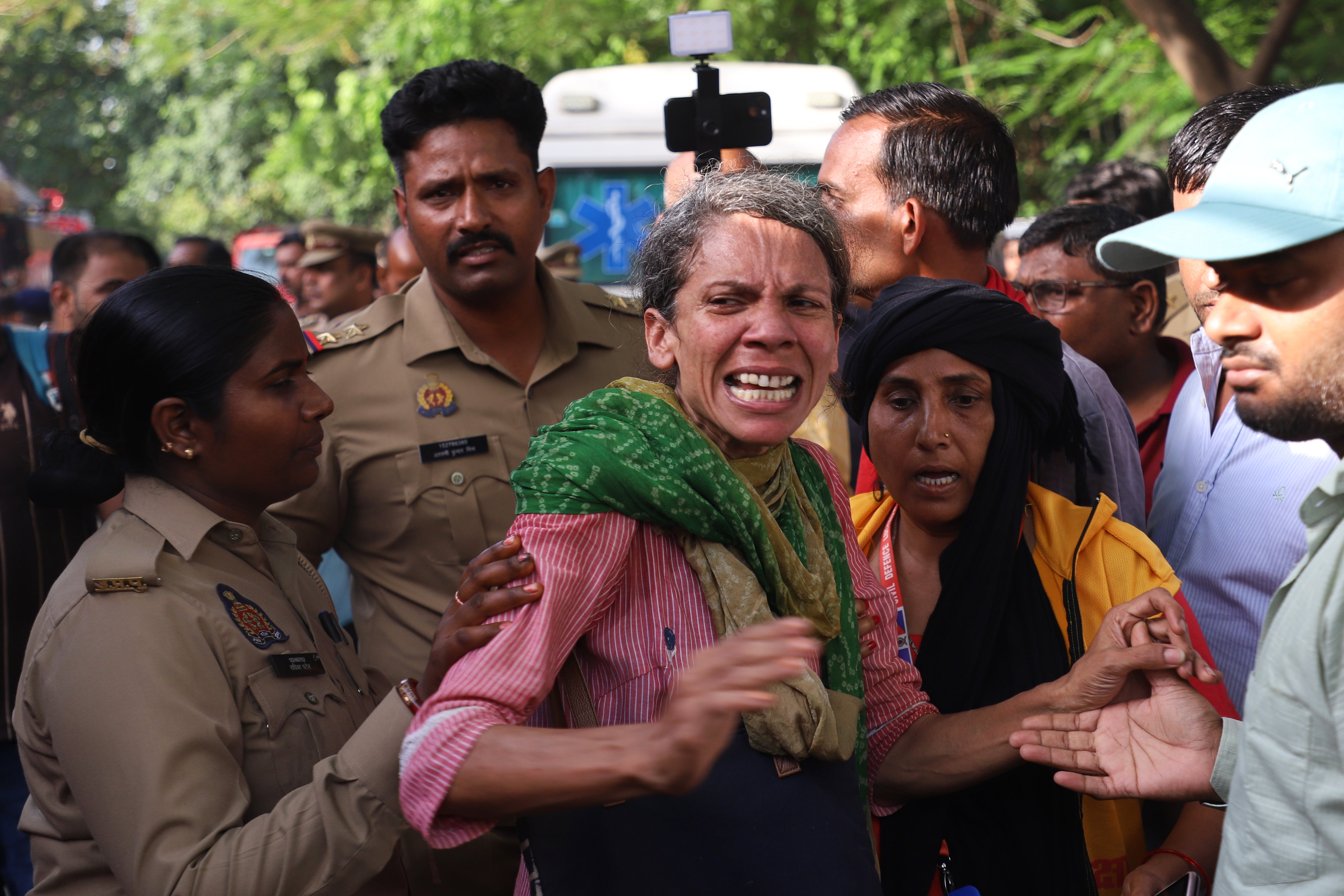 Family members of victims outside the building in Lucknow (AP)