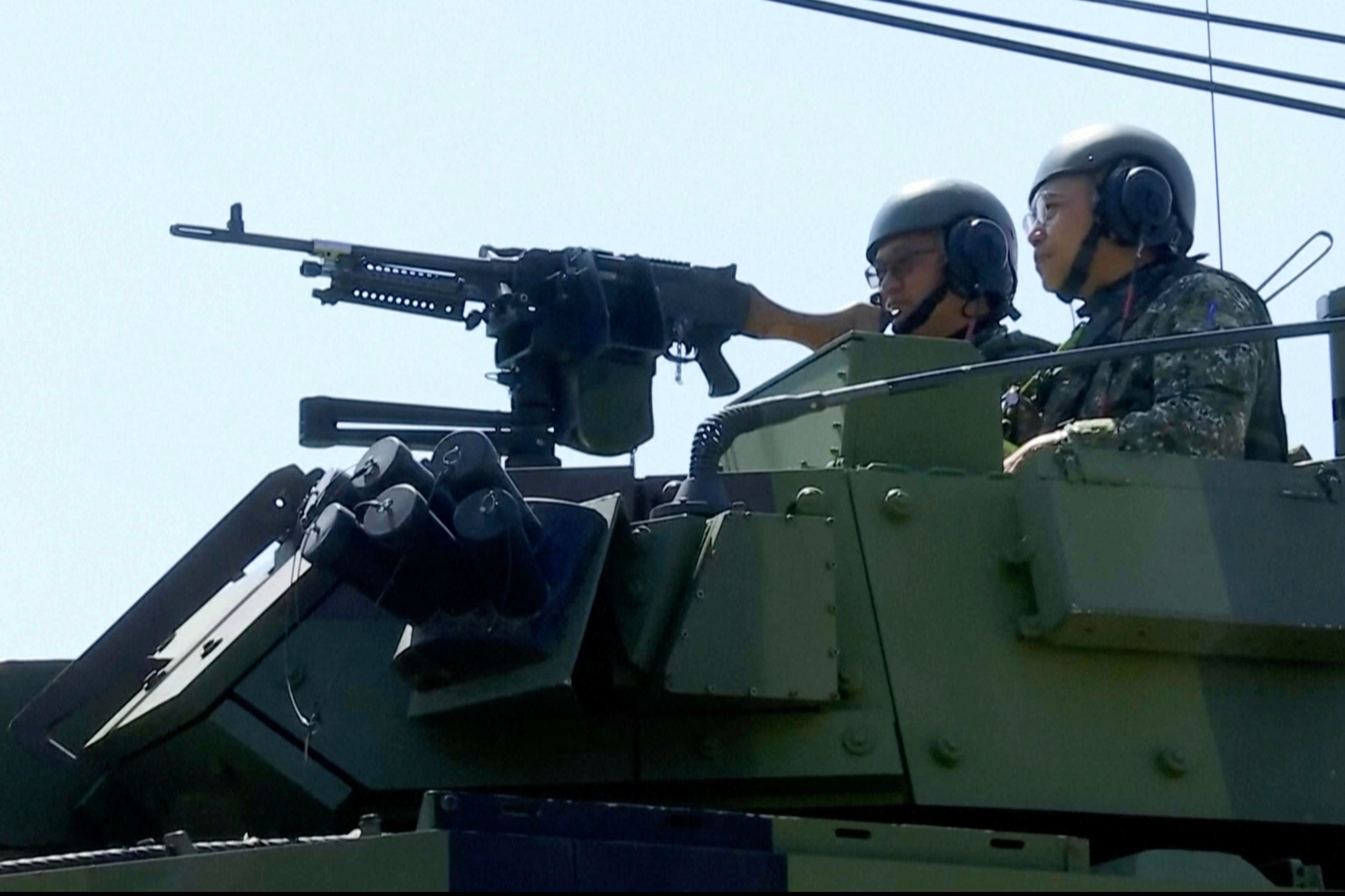 Soldiers look out from an armoured vehicle during military drills in Taoyuan, Taiwan, on 22 June 2026