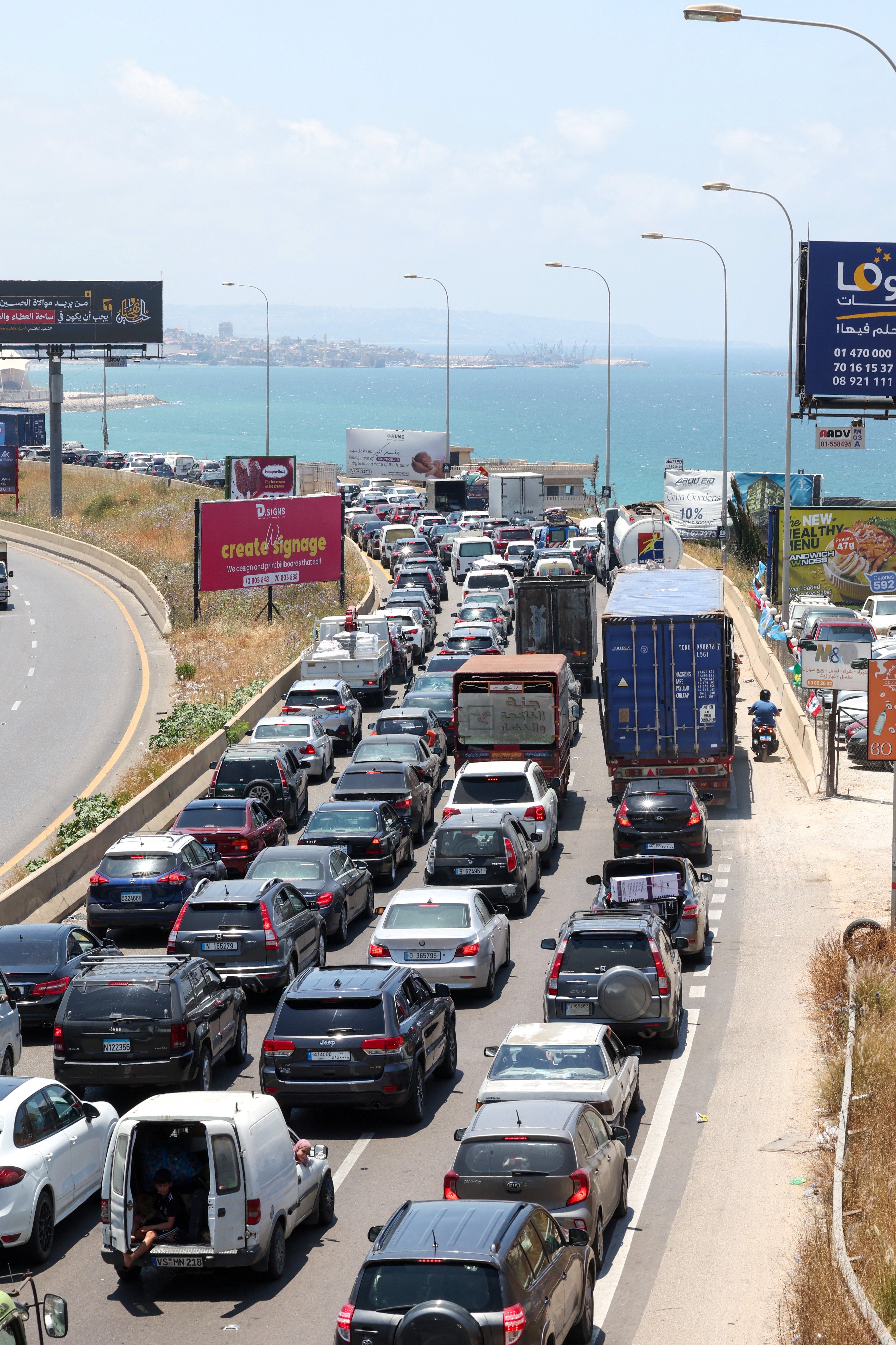 Displaced people make their way back to their homes in southern Lebanon following an interim deal between the U.S. and Iran, in Sidon on Tuesday 23 June. (Reuters)