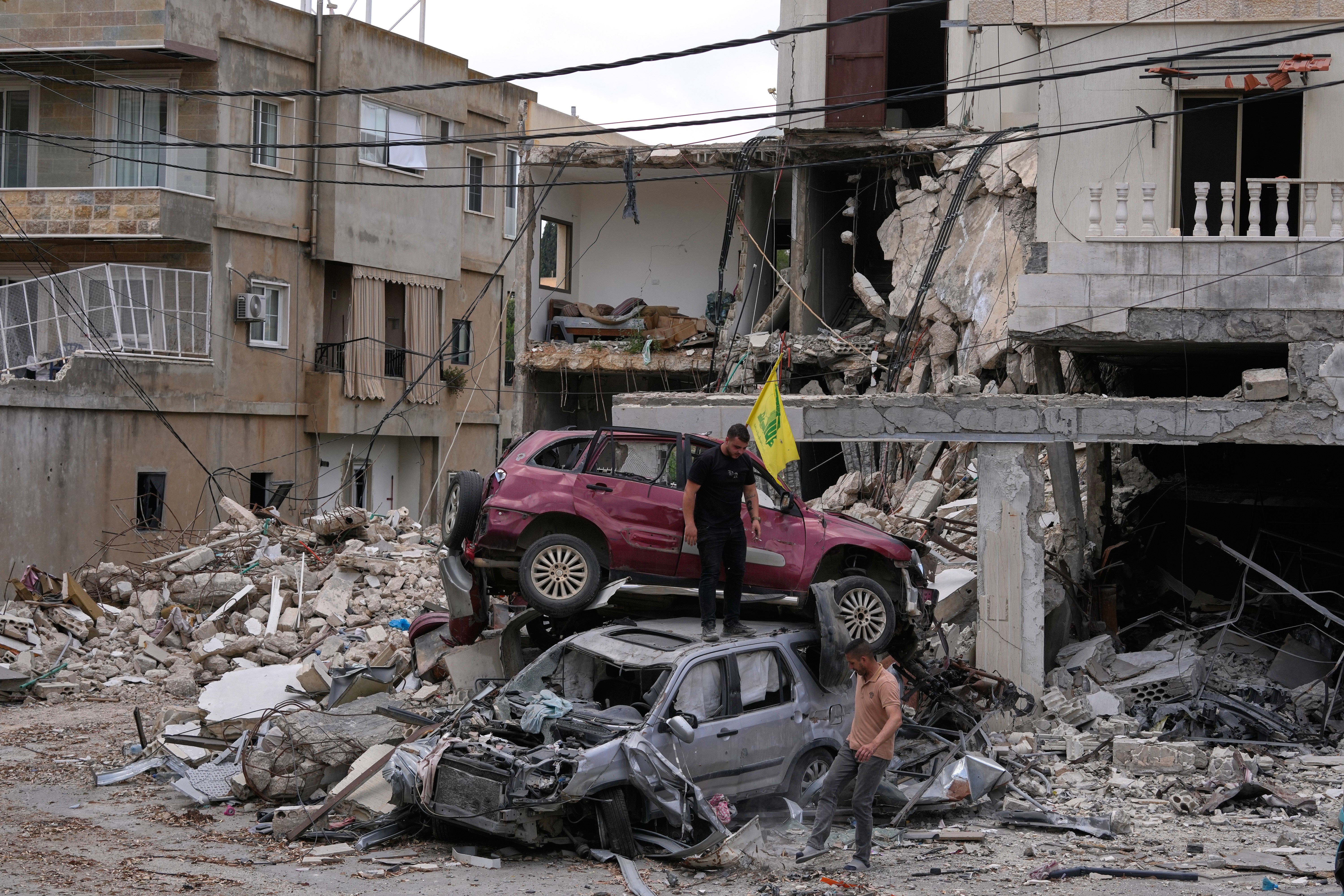 People check destroyed cars following a ceasefire between Israel and Hezbollah in the village of Maifadoun, southern Lebanon, Monday, June 22, 2026. (AP Photo/Mohammed Zaatari) (AP)
