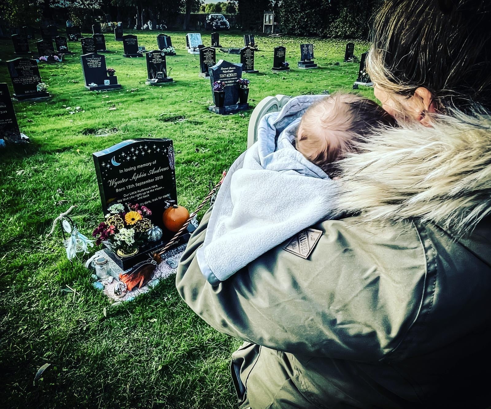 Sarah Andrews with her son Bowie at her daughter Wynter's grave
