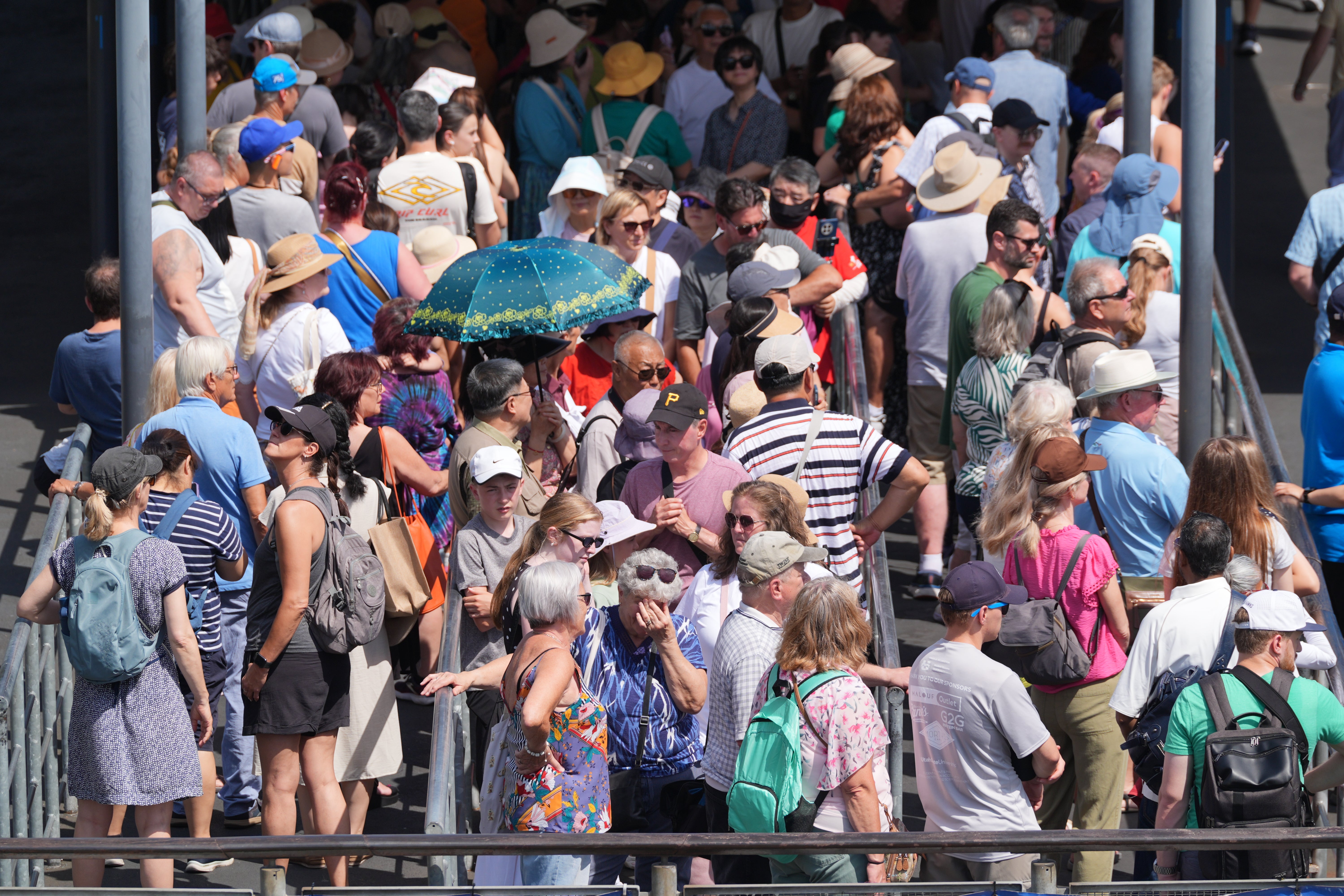 People queue for a river taxi in Westminster, central London, during the heatwave (Yui Mok/PA) (PA Wire)