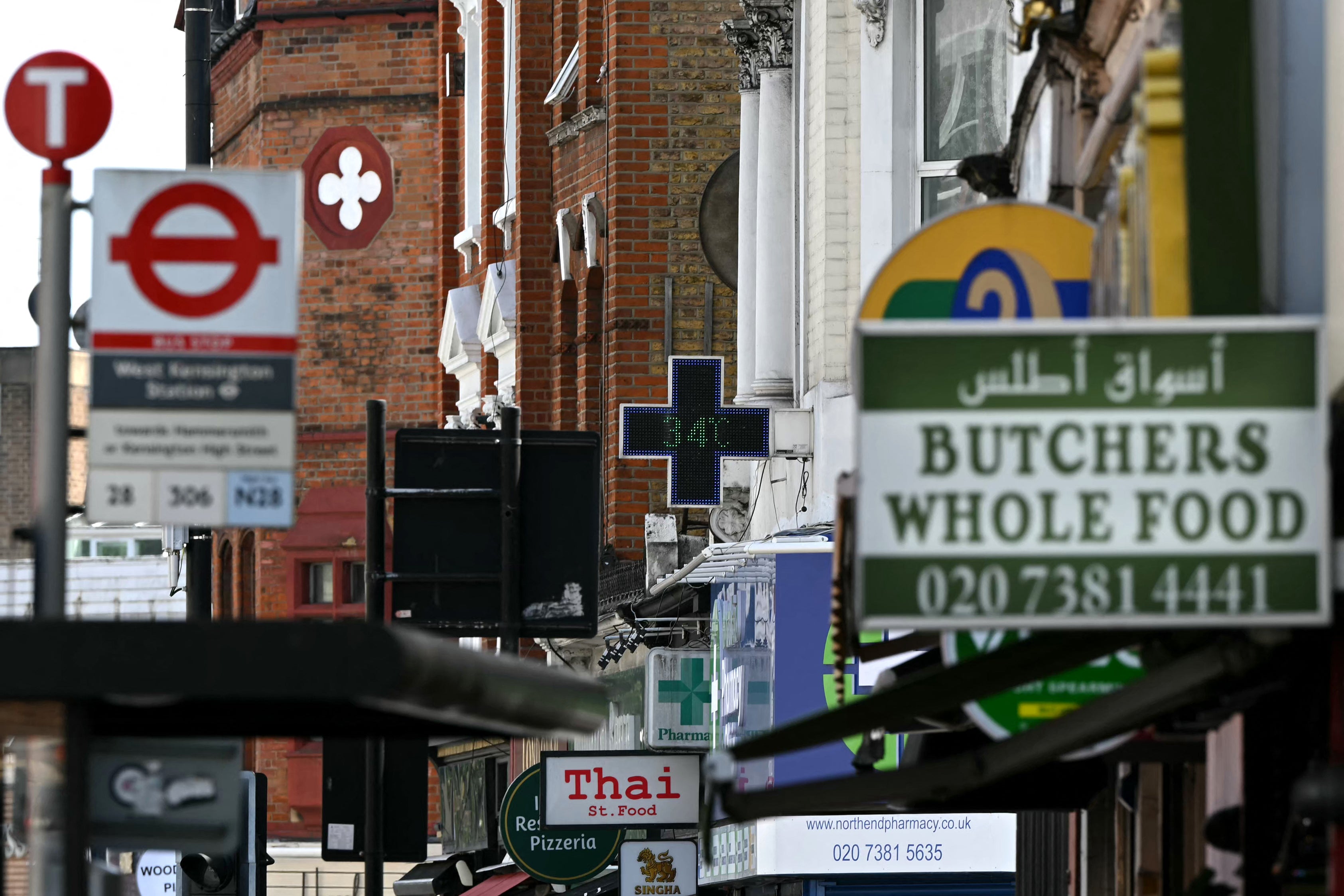 A sign outside of a pharmacy displays the temperature in west London, on June 23, 2026