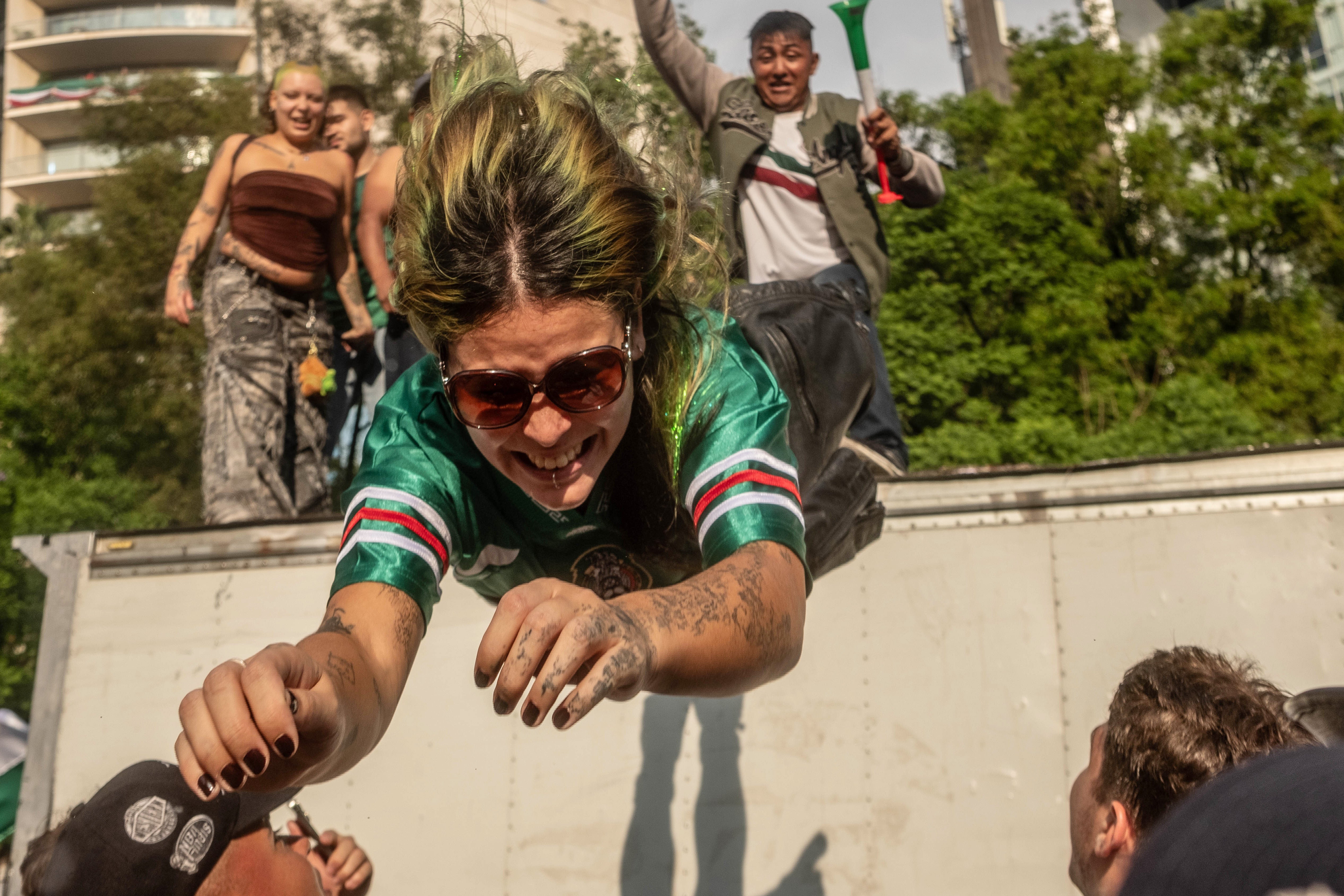 A fan jumps from a truck into the crowd during the celebrations after Mexico’s victory against South Africa on June 11, 2026