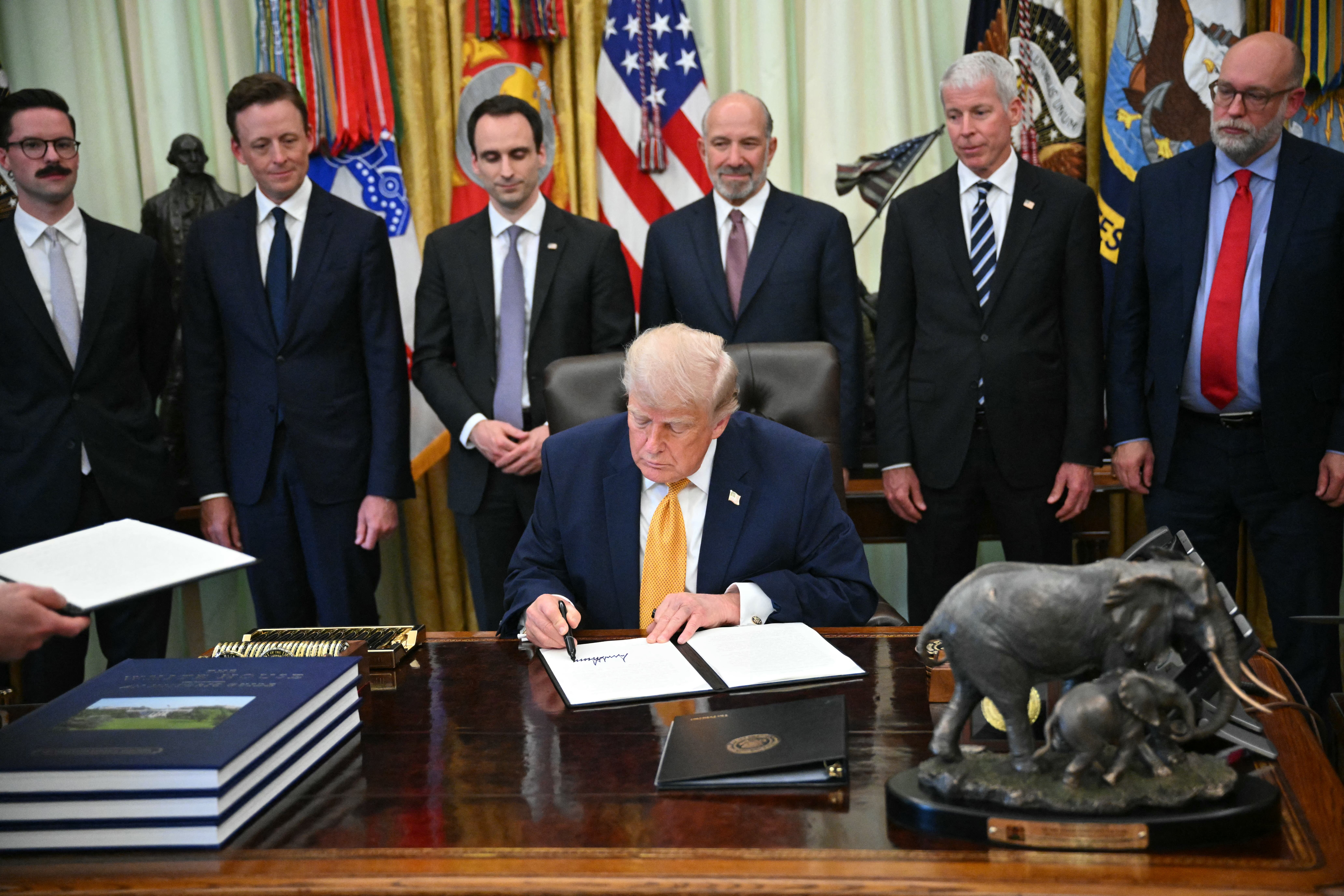 Donald Trump signs an executive order at the White House in June 2026. He previously issued executive orders defining sex as strictly male or female at birth