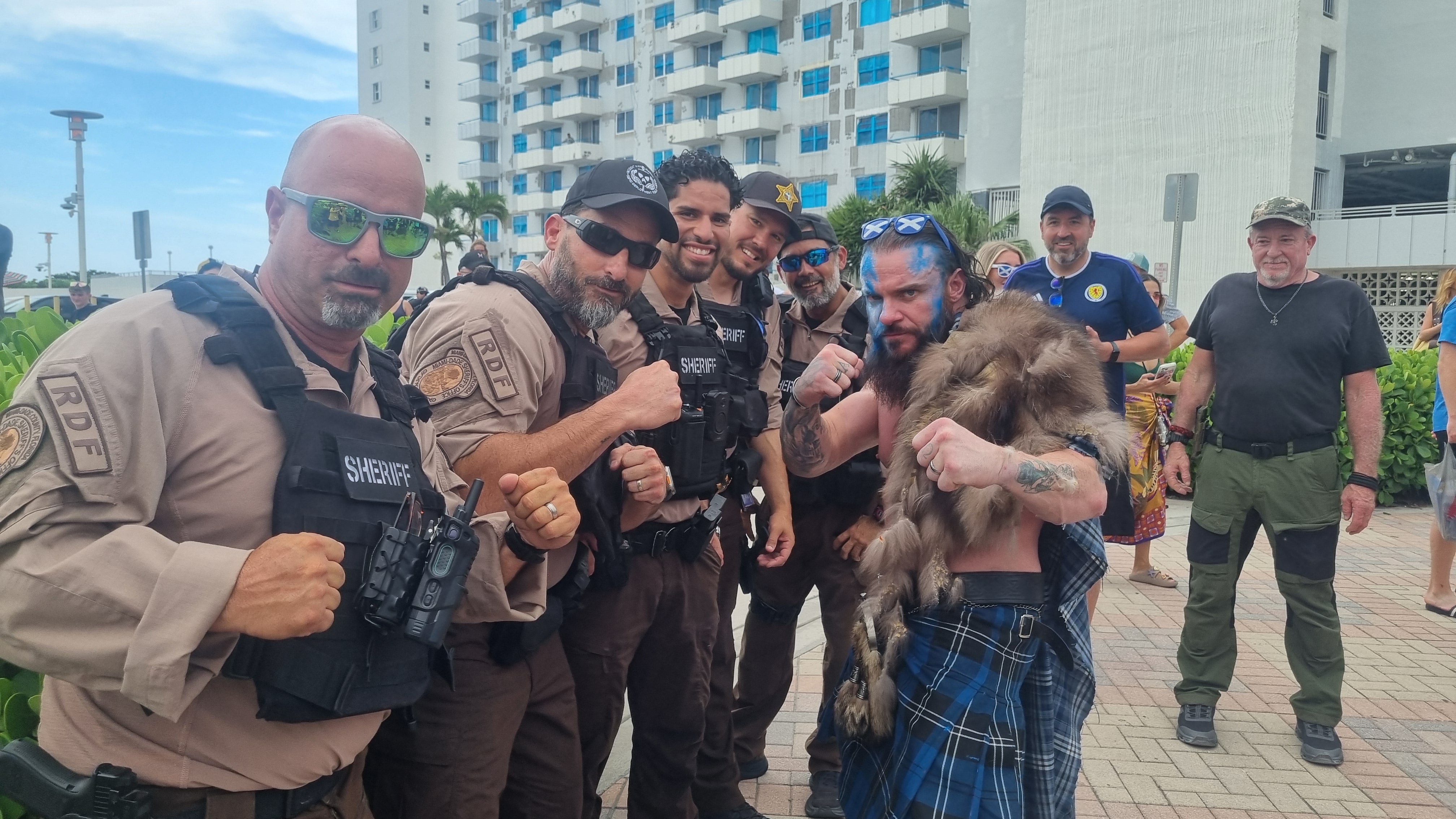 Luke Scouler, a professional wrestler who goes by Crixus, now lives in the US but is originally from Bellshill. Local police posed for pictures with him, impressed by his costume. (Ryan McDougall/PA)