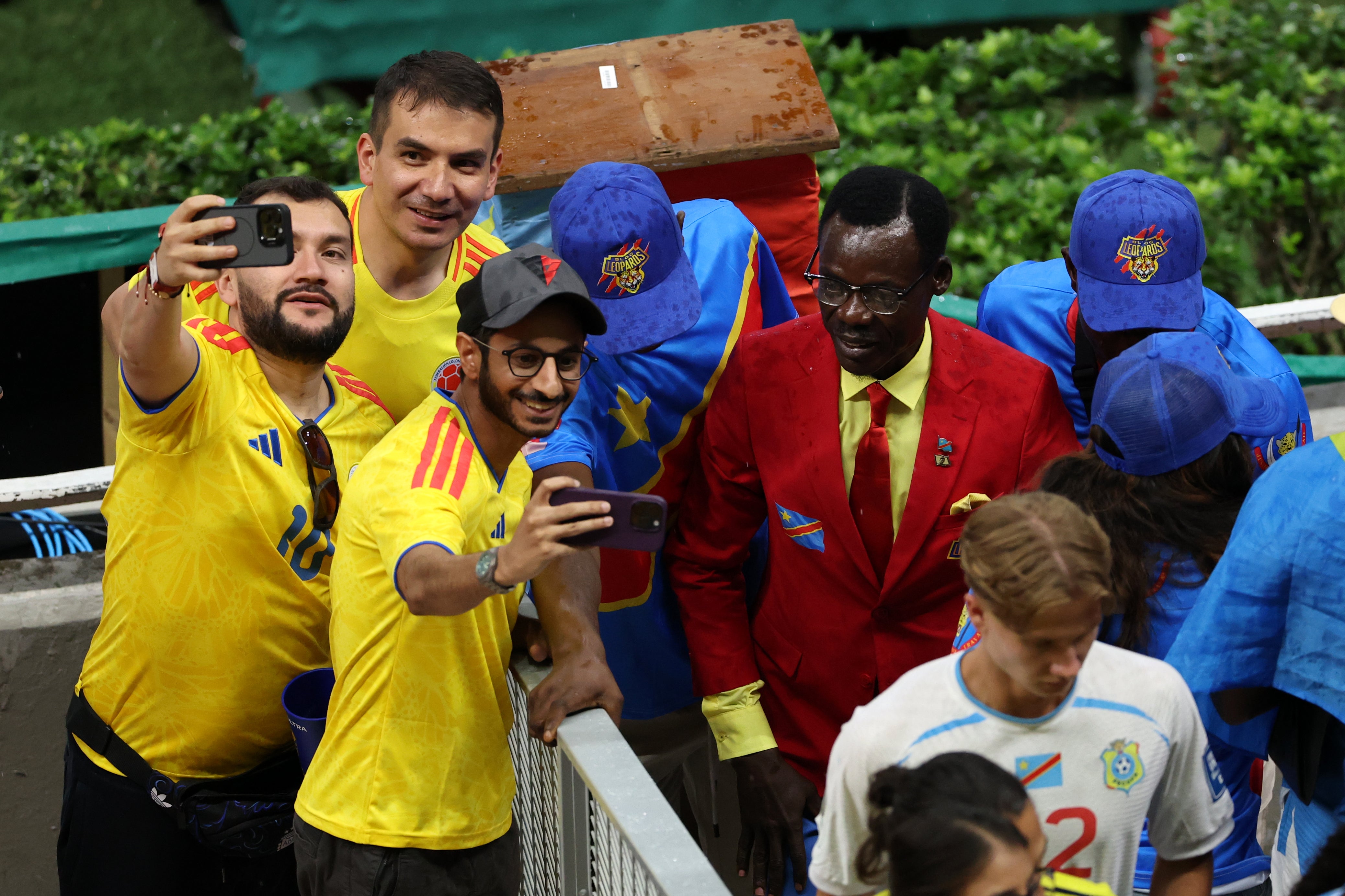 Colombia fans pose for photos with Congo DR fan Michel Nkuka Mboladinga
