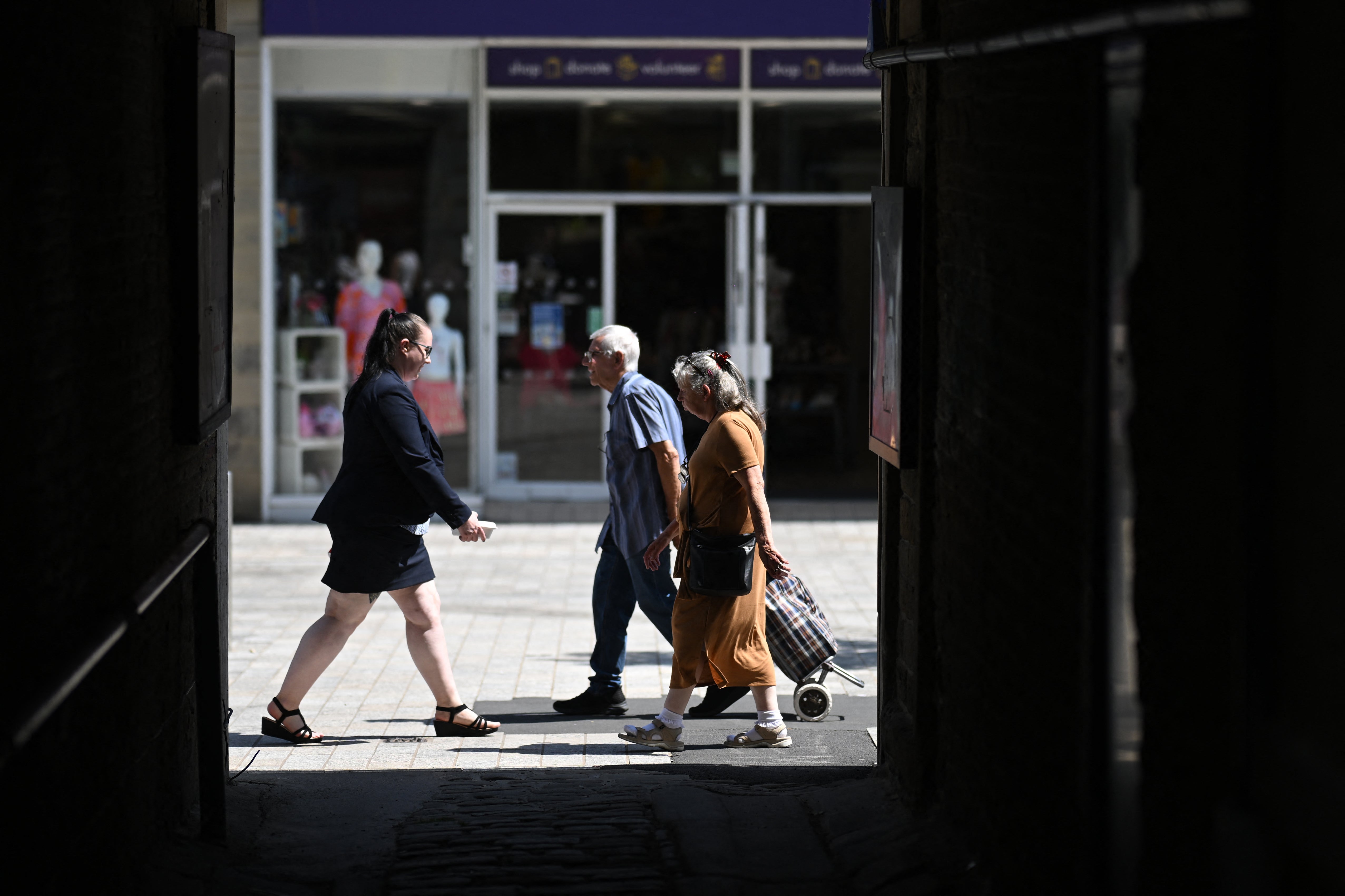 People walk through the town centre in Huddersfield in northern England on 23 June 2026