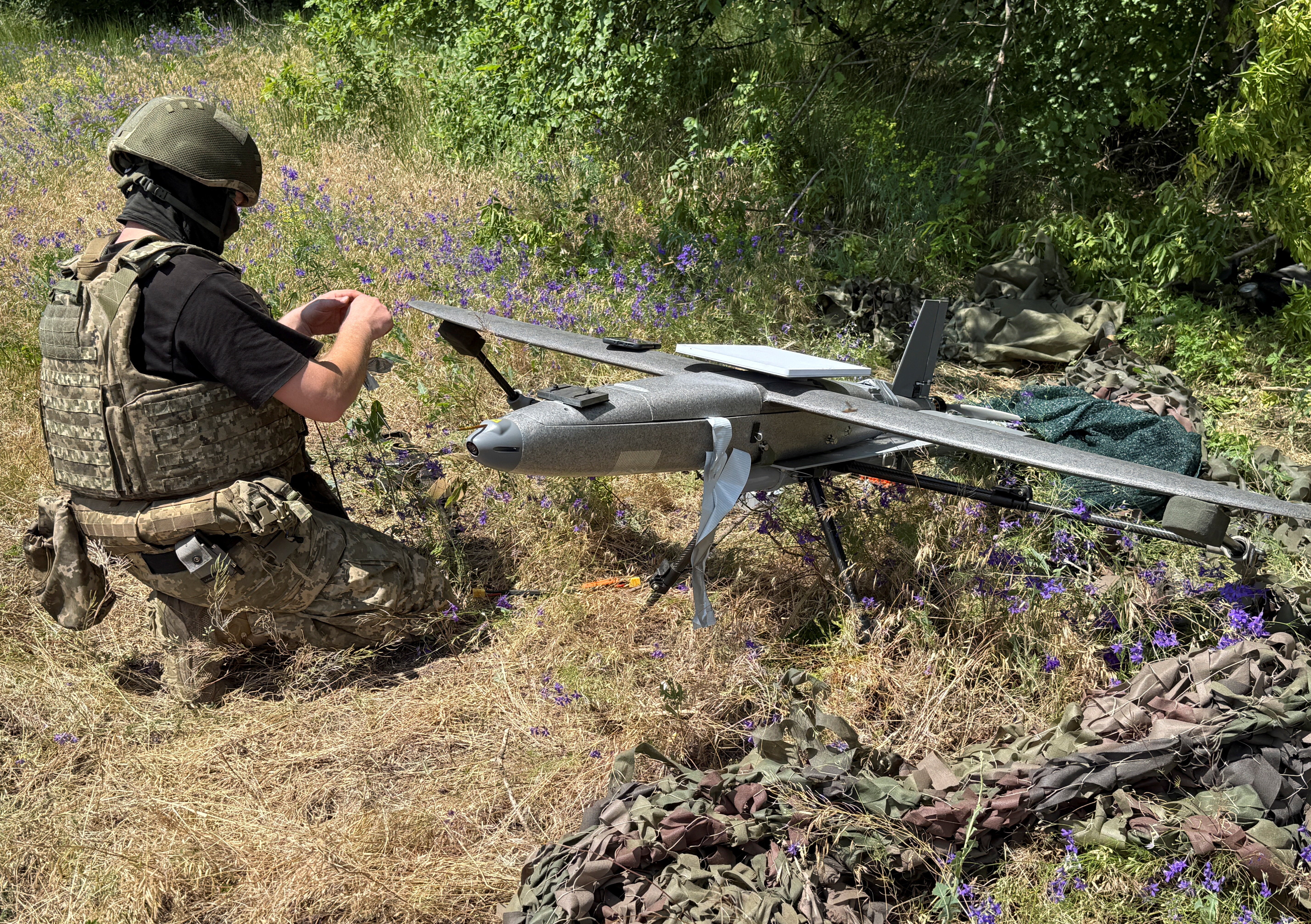 A serviceman of the 25th Separate Airborne Brigade of the Air Assault Forces of Ukraine prepares to launch a Hornet middle strike drone towards Russian troops (Reuters)