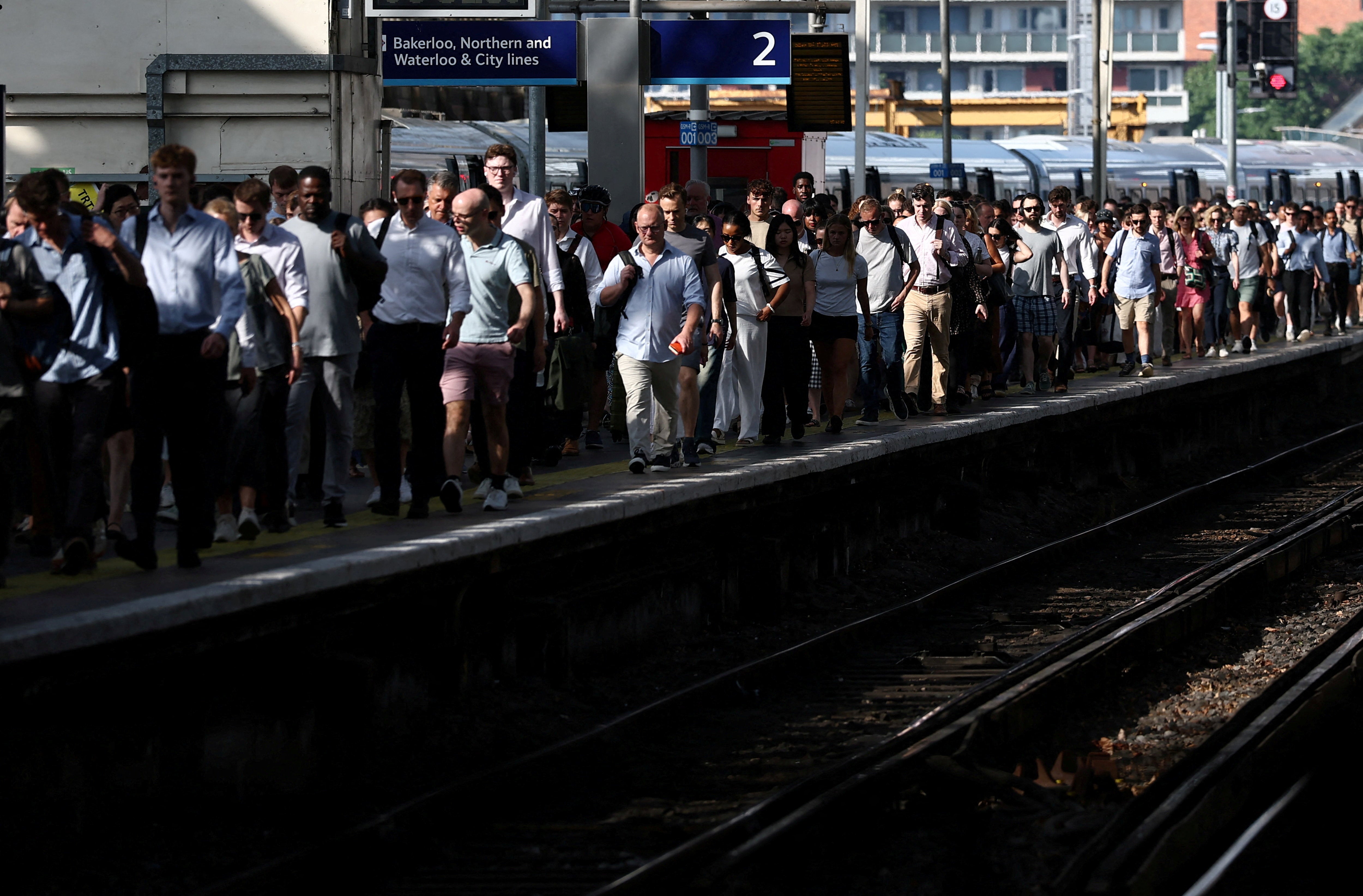 Commuters battle the heat at Waterloo Station in London