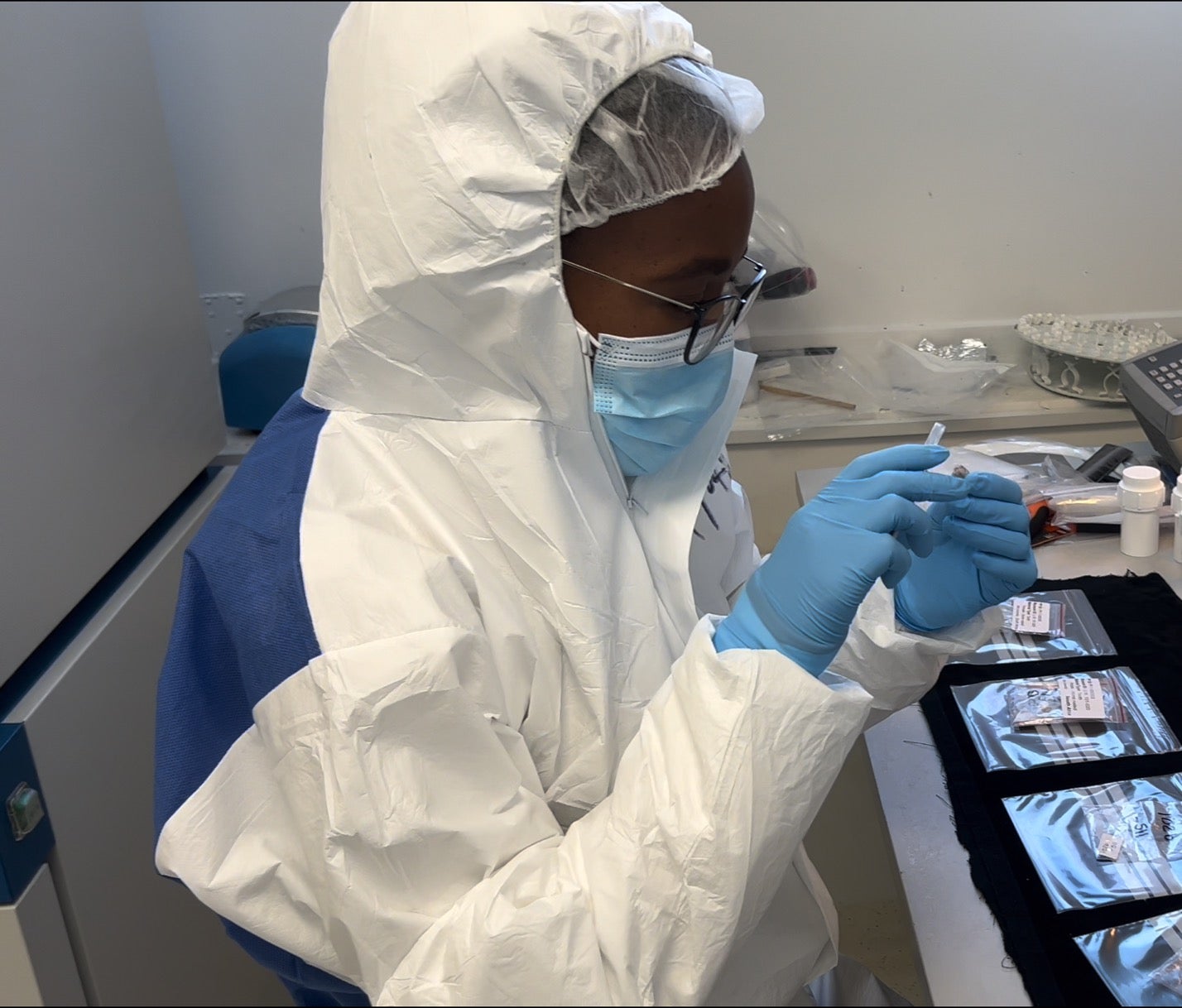 Scientist Palesa Madupe looking at specimens in the ancient biomolecules clean laboratory at the Globe Institute, University of Copenhagen.