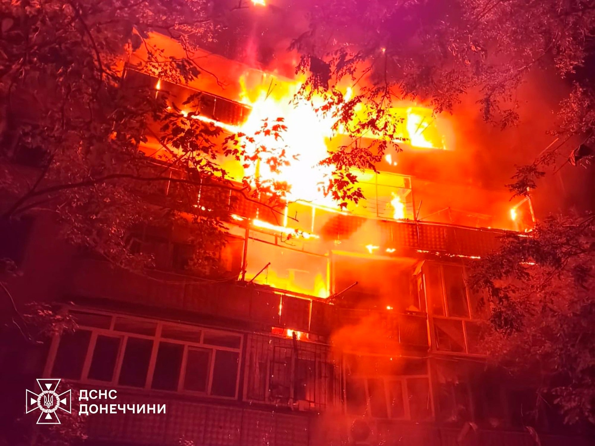 In this photo provided by the Ukrainian Emergency Service, a fire rages in a multistory building after Russia's air attack on eastern Ukraine