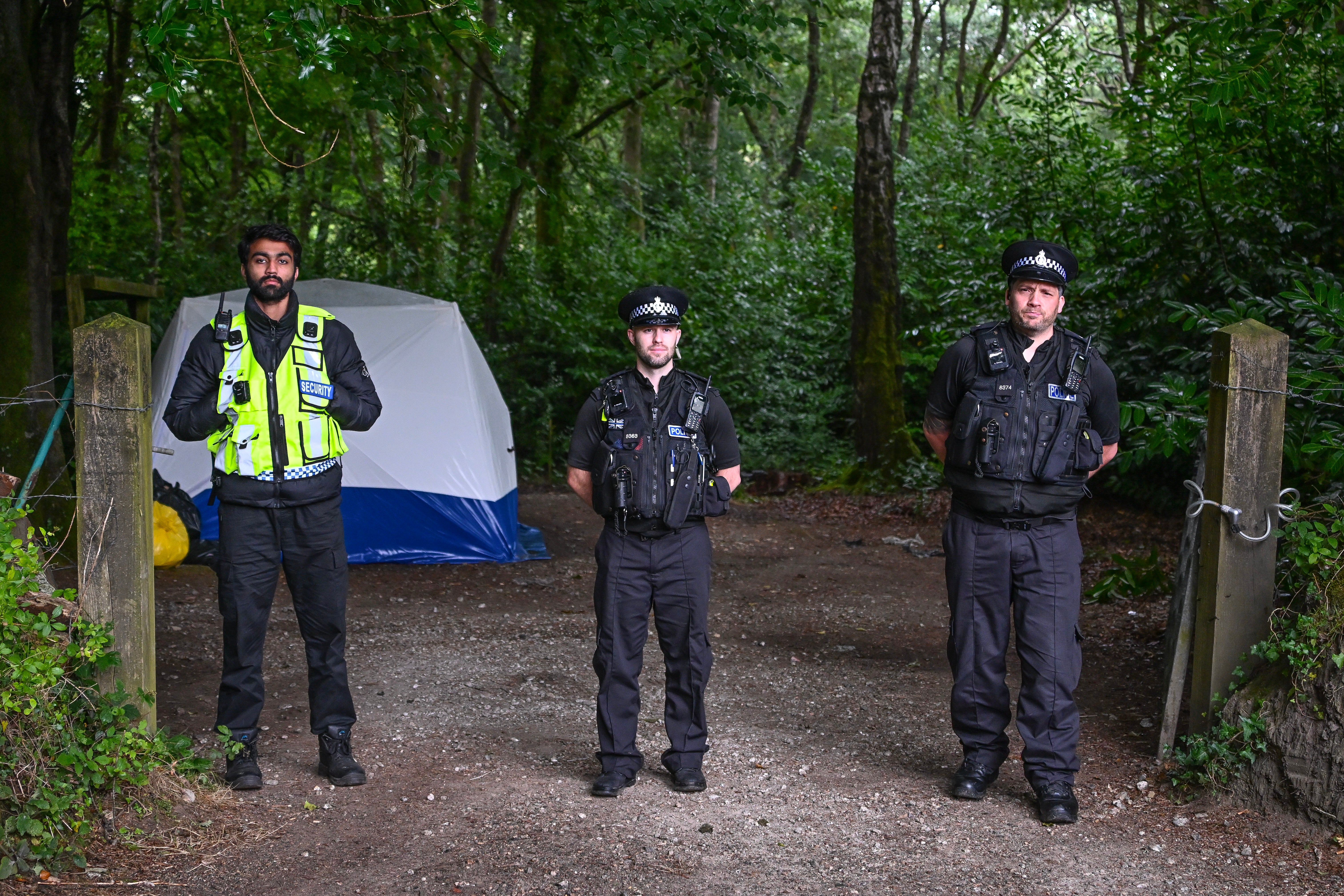 A manned police cordon in place in the woods near the village of Sticker (Getty)
