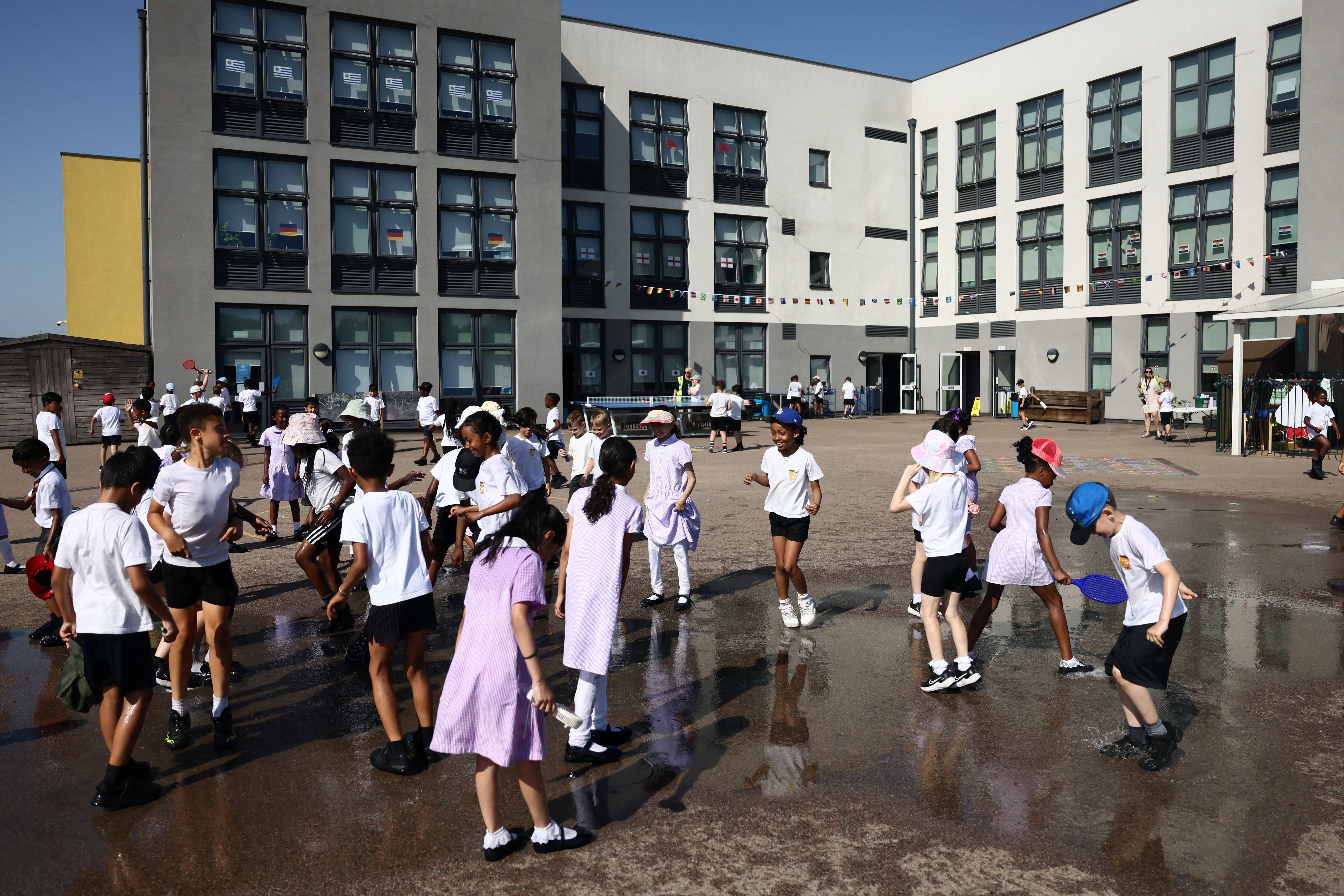 Students play outside after water play at Harris Academy Elementary Mayflower school