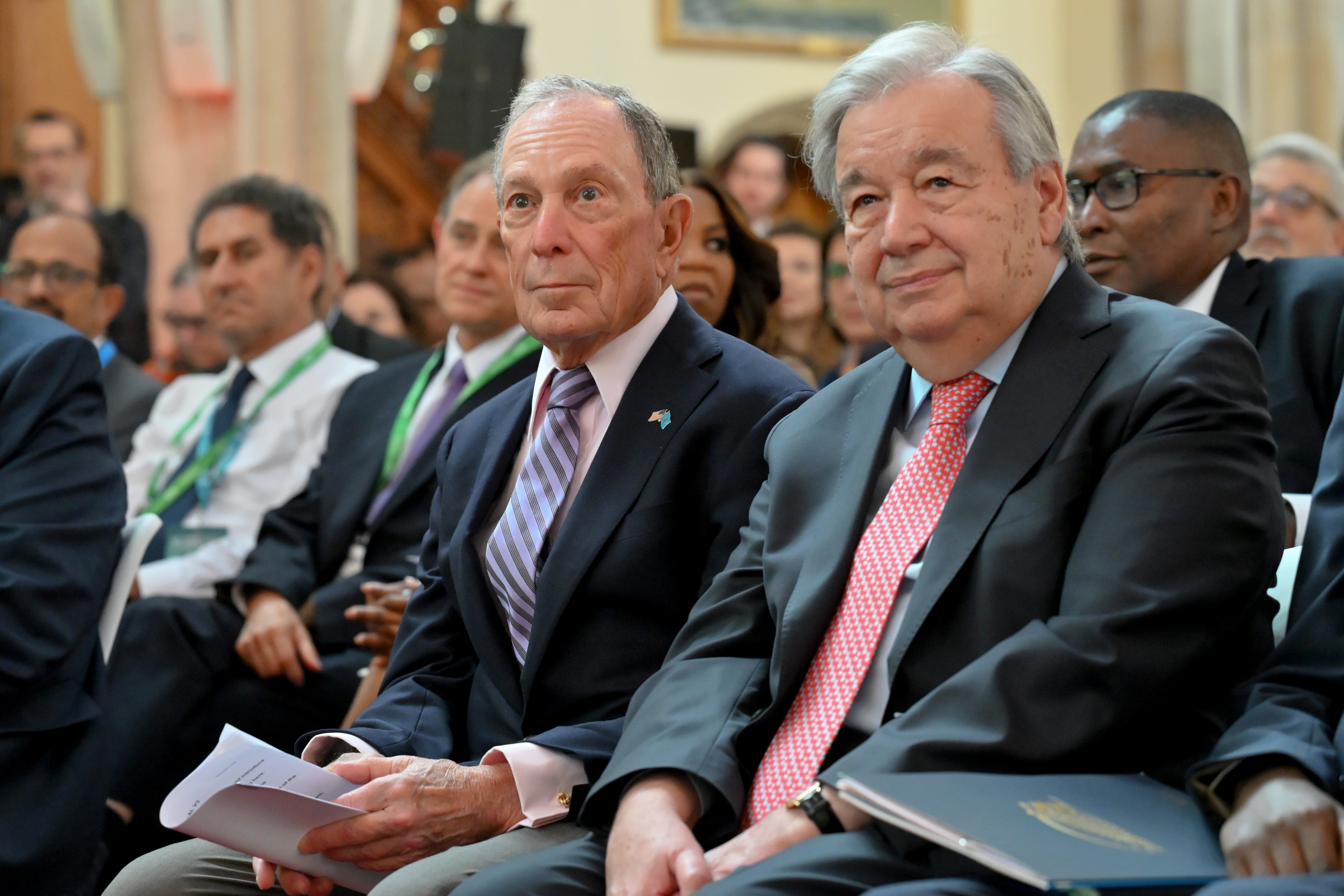 Former mayor of New York Mike Bloomberg (L) sits alongside UN Secretary-General António Guterres at London Climate Action Week