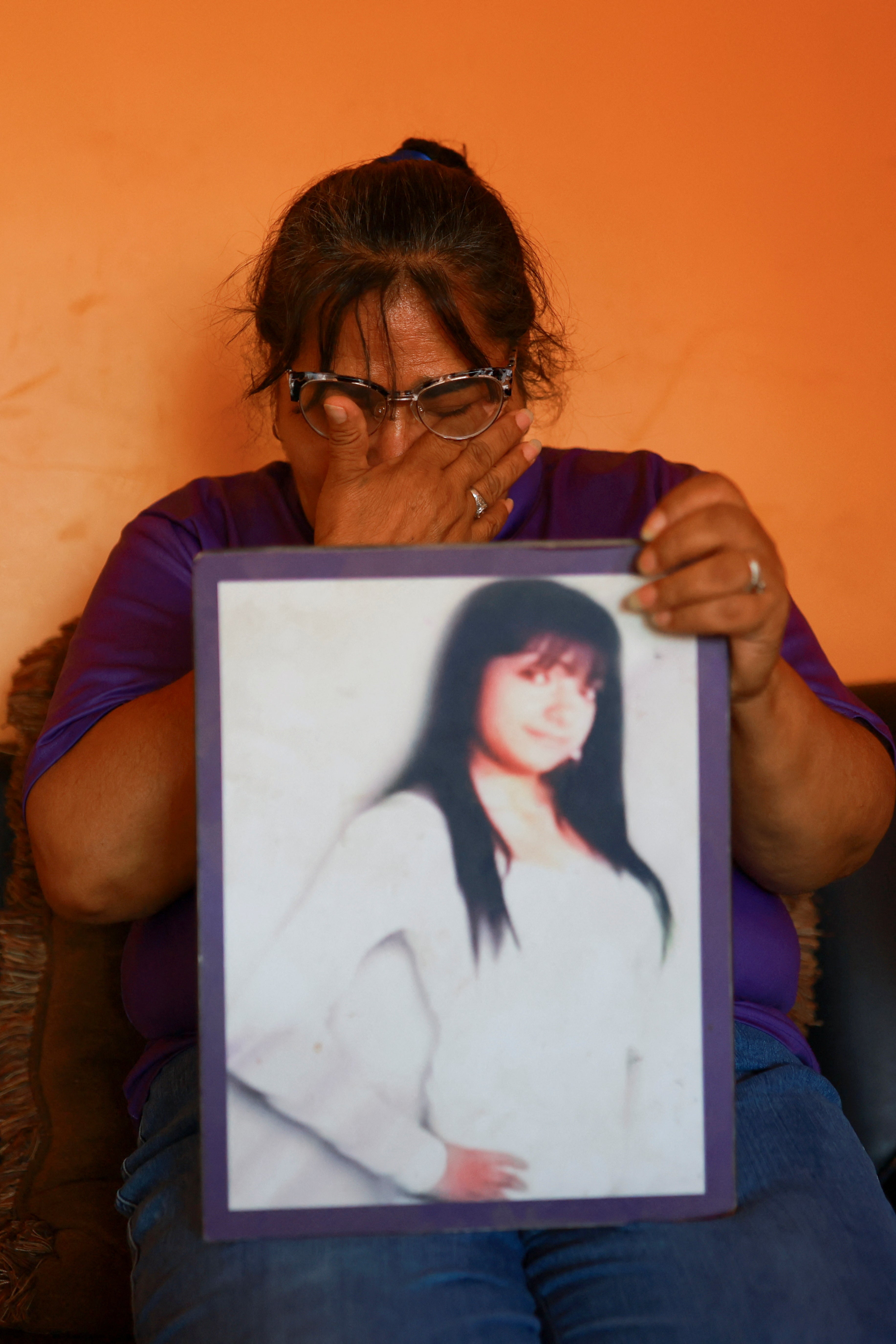 Laguna holds a photo of her daughter, Idaly Juache