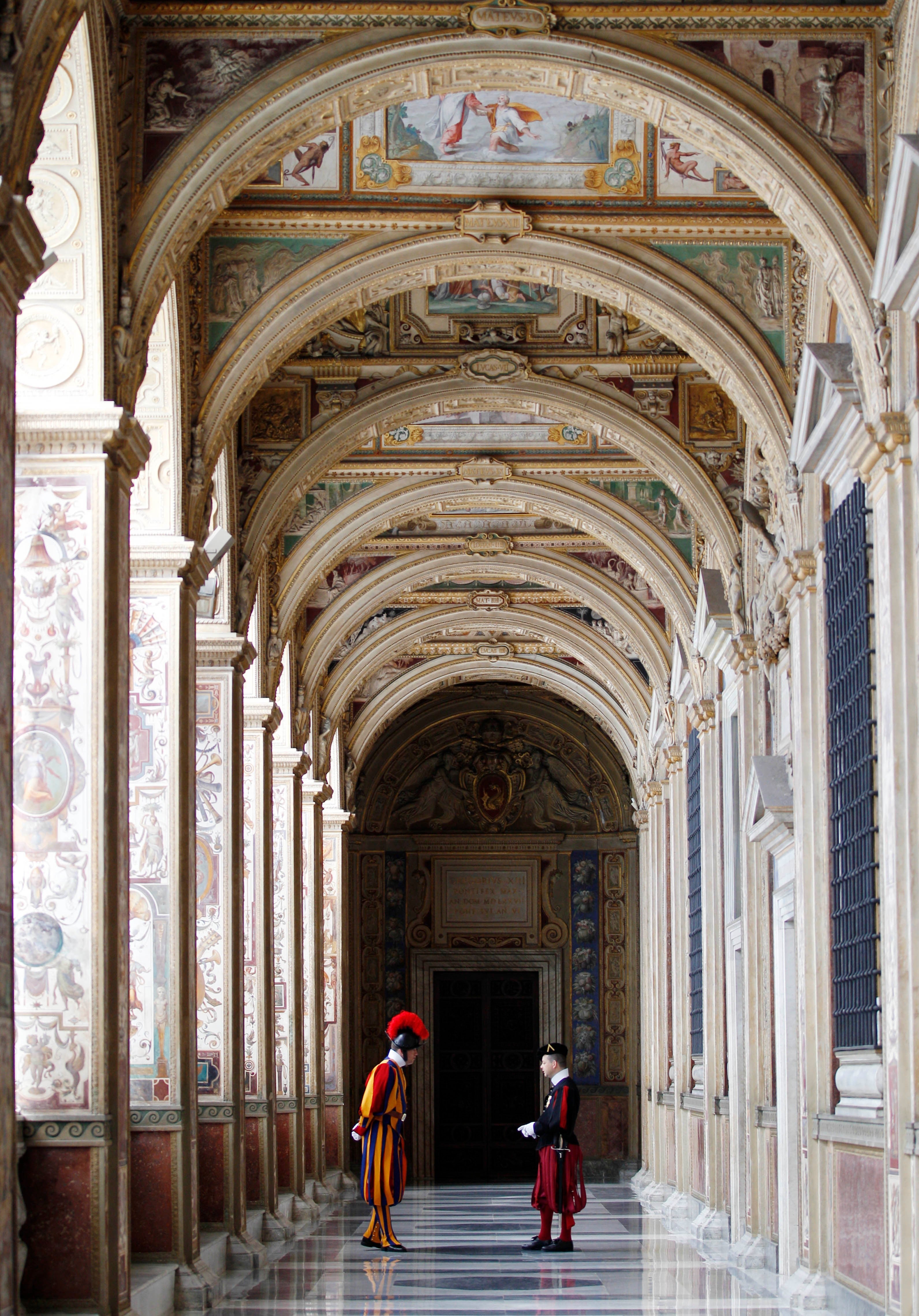Swiss guards talk in a Vatican corridor (AP Photo/Alessandra Tarantino)