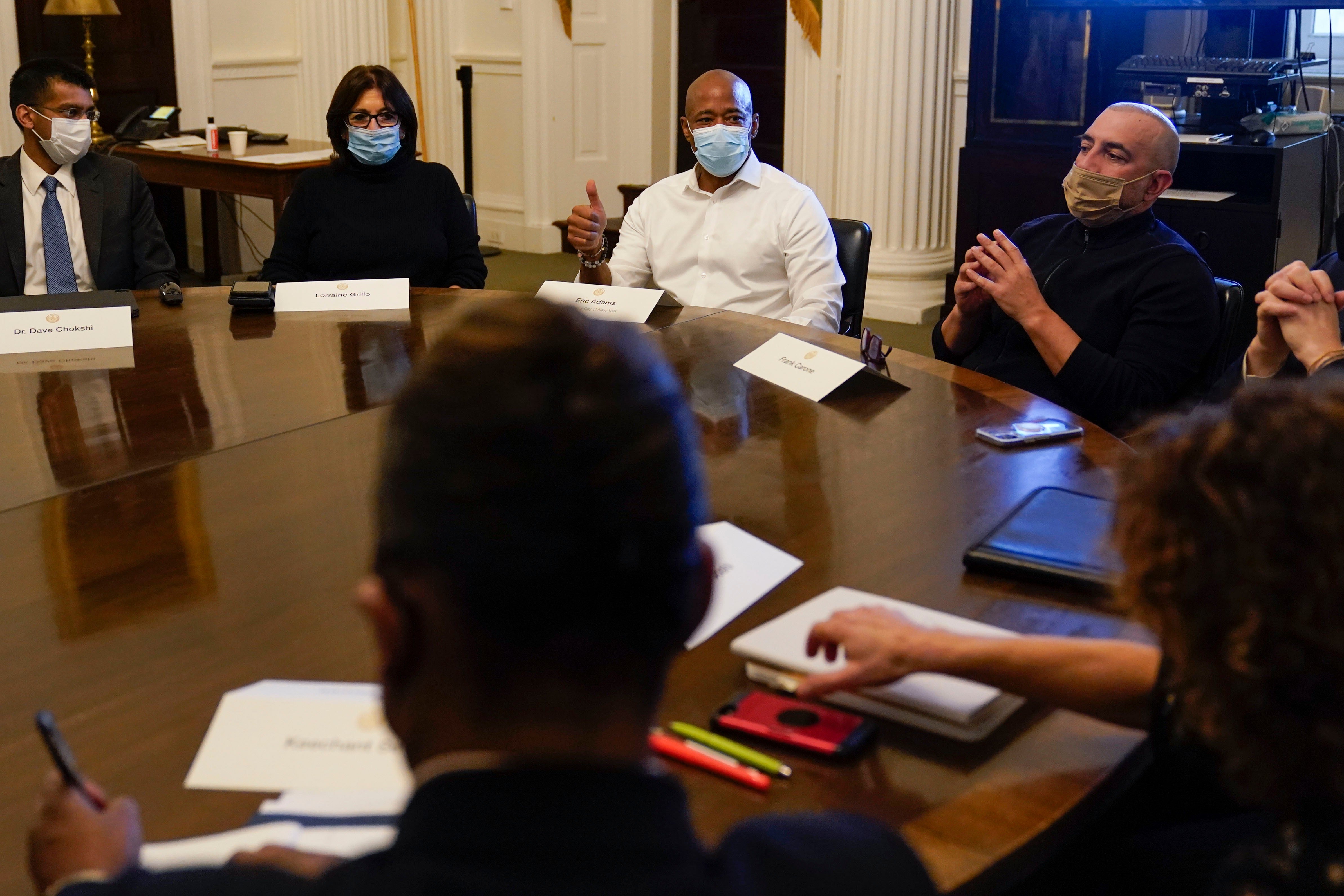 Then-New York City Mayor Eric Adams, center, speaks during a cabinet meeting on his first day in office in New York, Jan. 1, 2022. To Adams' right is his Chief of Staff Frank Carone (AP Photo/Seth Wenig)