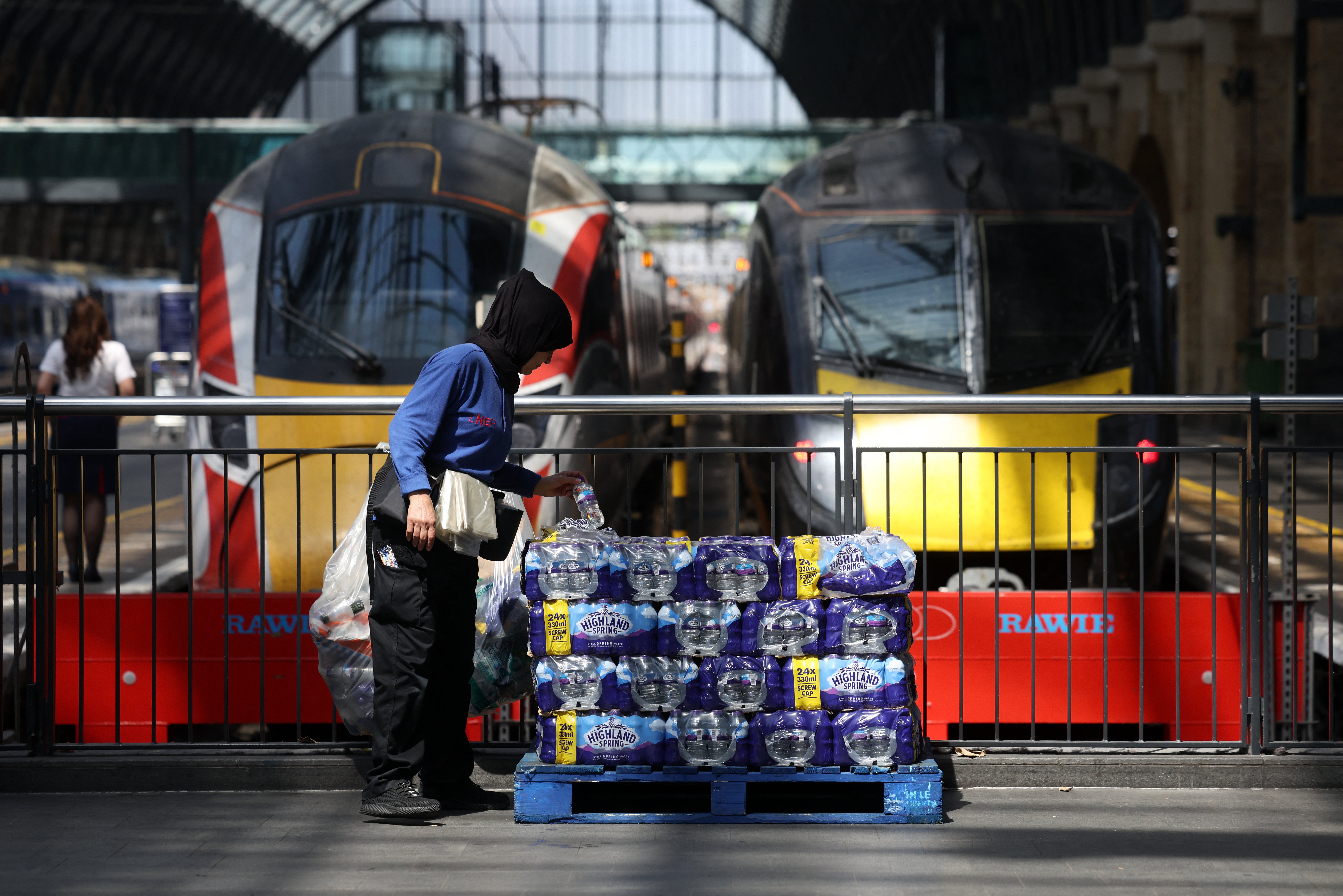 Stacks of water bottles are laid out for people to take at Kings Cross station in central London