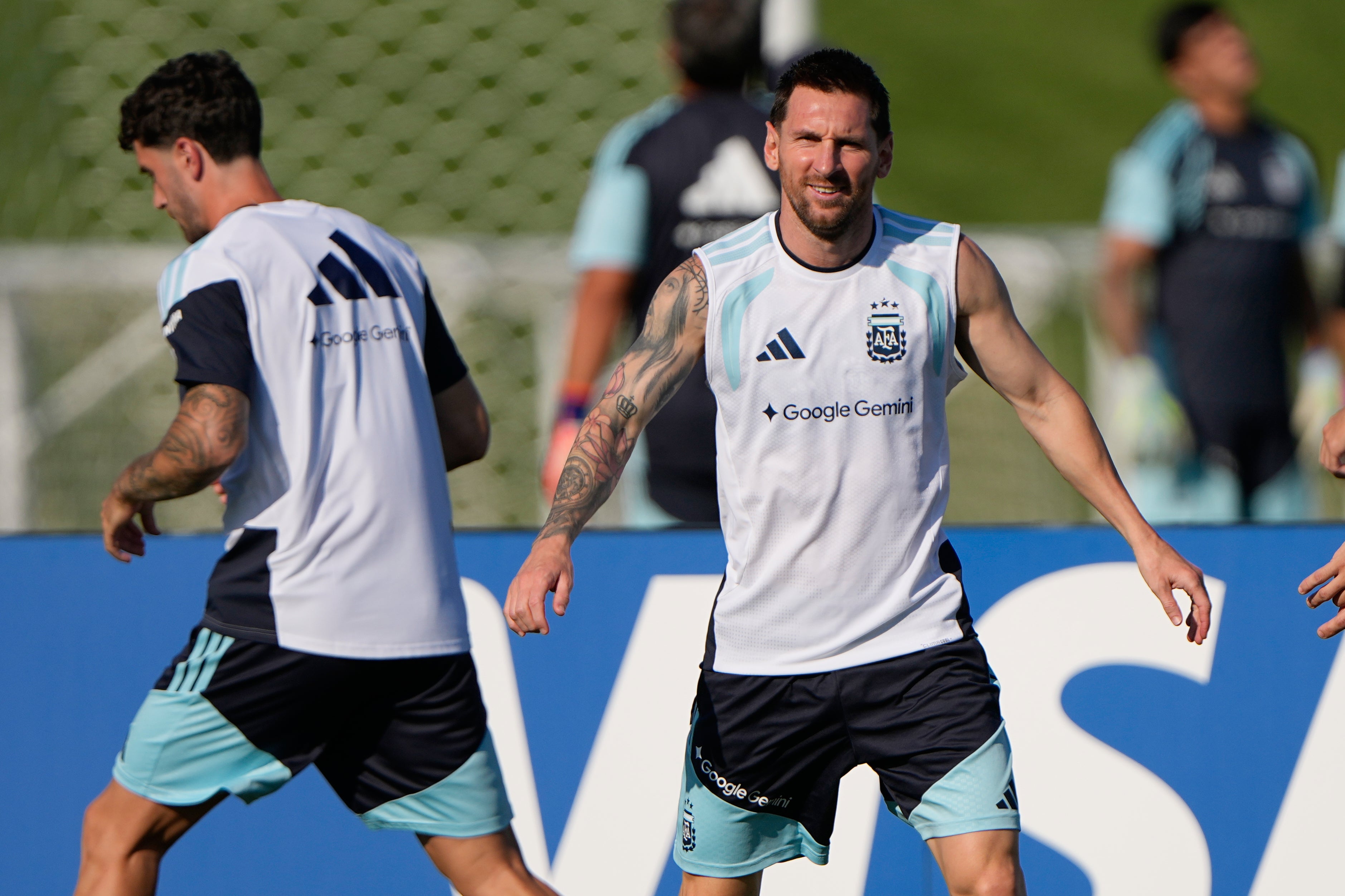 Argentina's Lionel Messi, right, trains with teammates for the World Cup soccer tournament