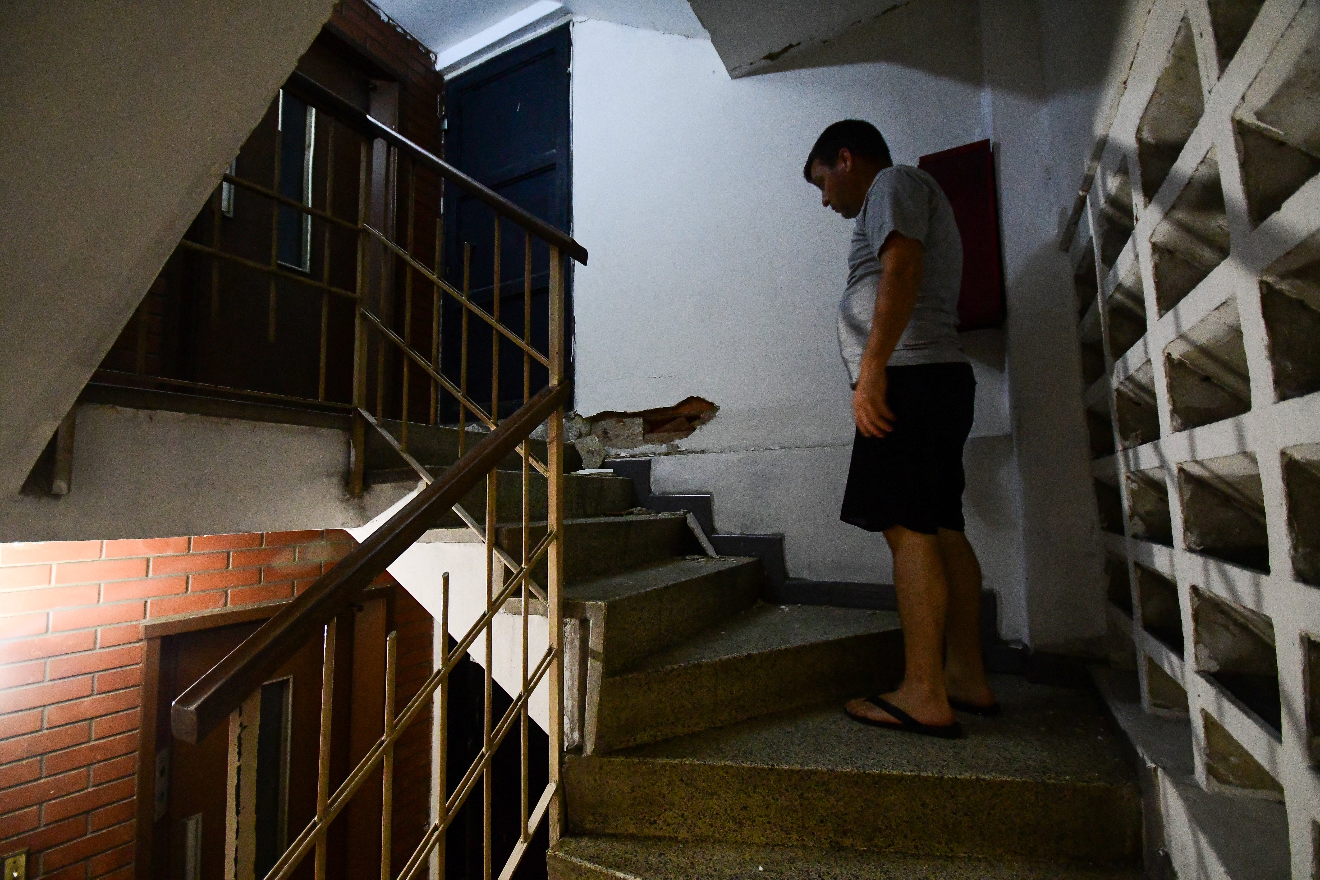 A man stands inside a damaged building following an earthquake in Valencia, Venezuela on 24 June 2026