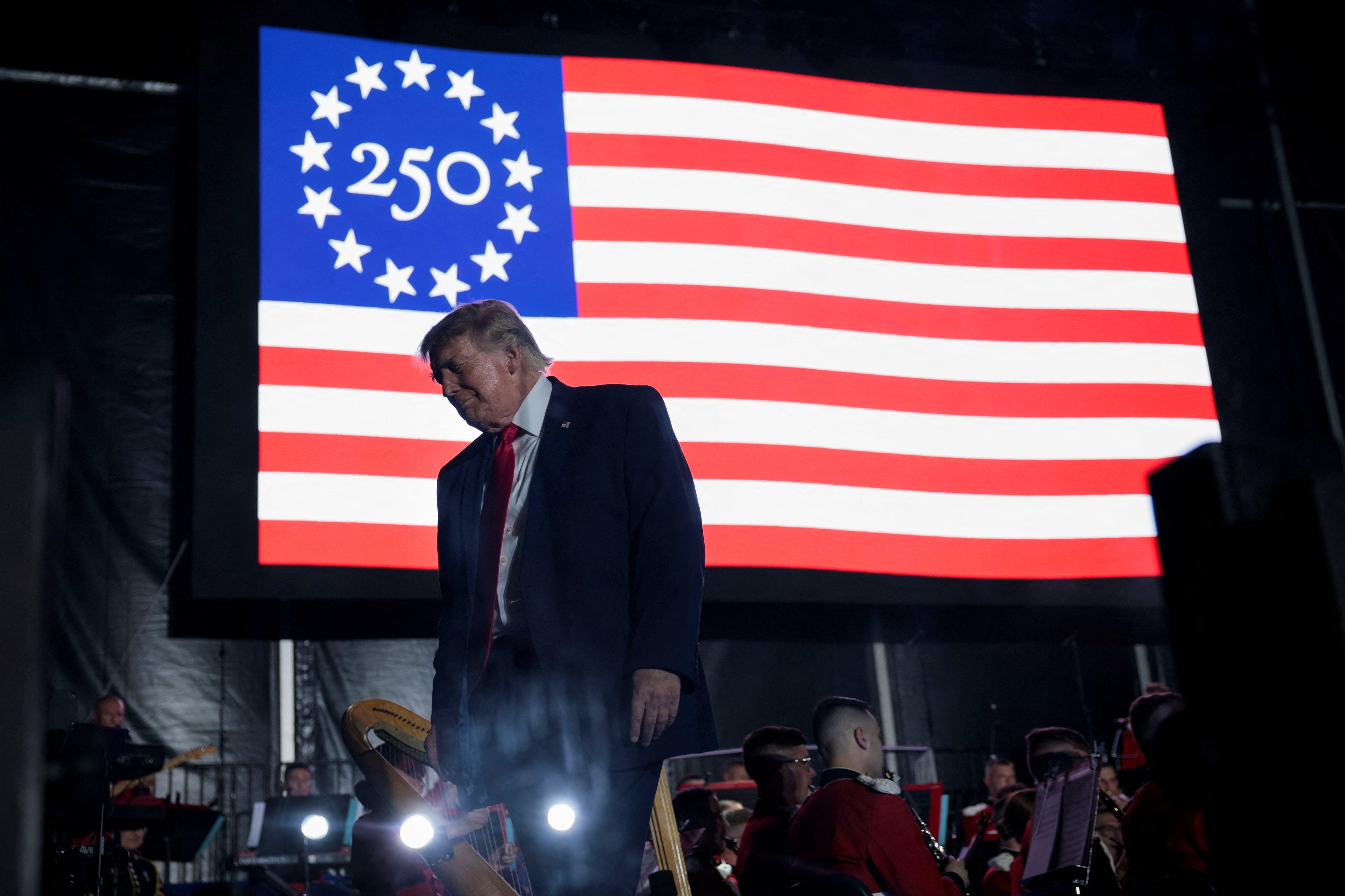 US president Donald Trump walks off stage after speaking at a rally to kick off the Great American State Fair in celebration of the 250th anniversary of US independence