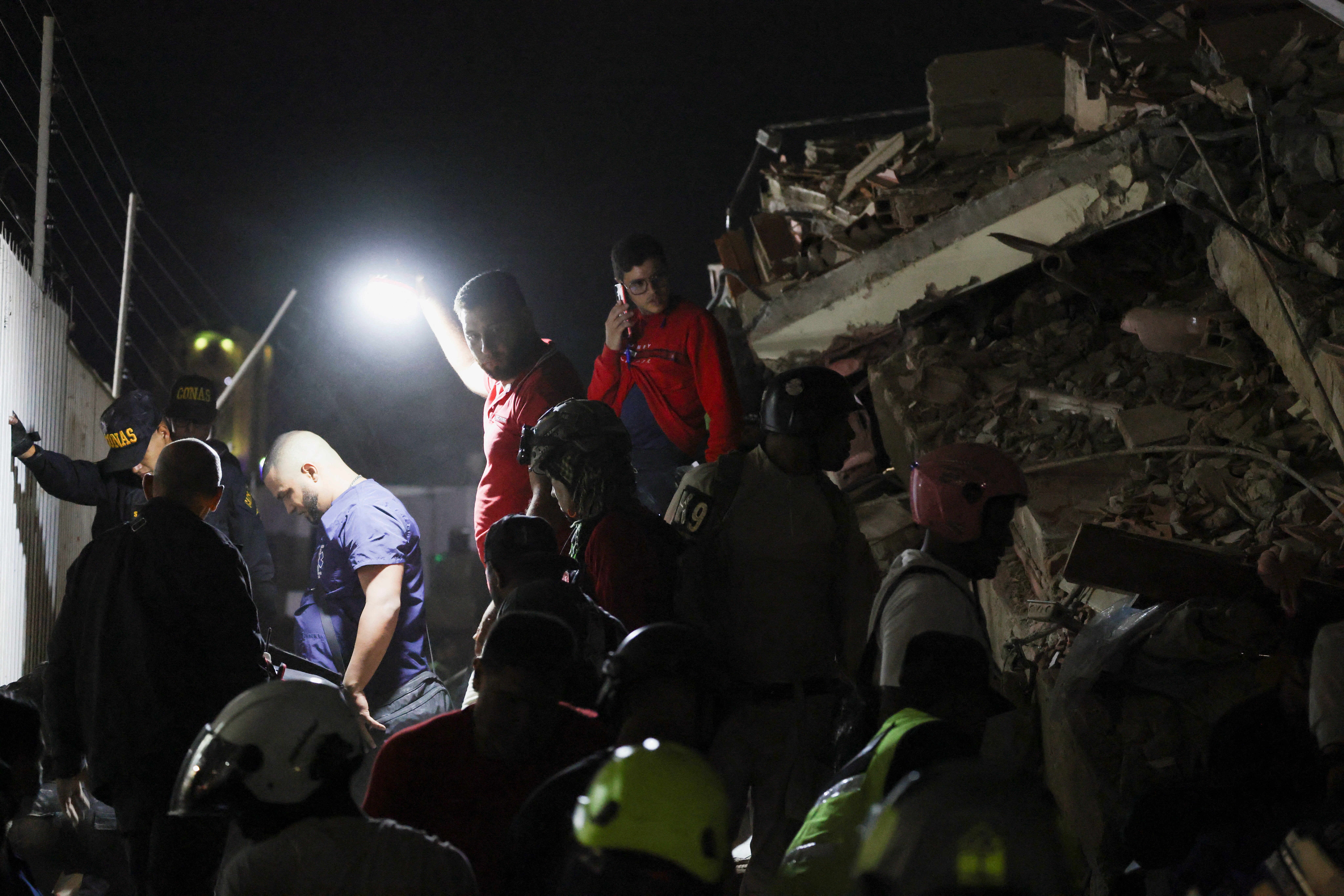 People inspect the site of a collapsed building after an earthquake in Caracas, Venezuela, 24 June 2026