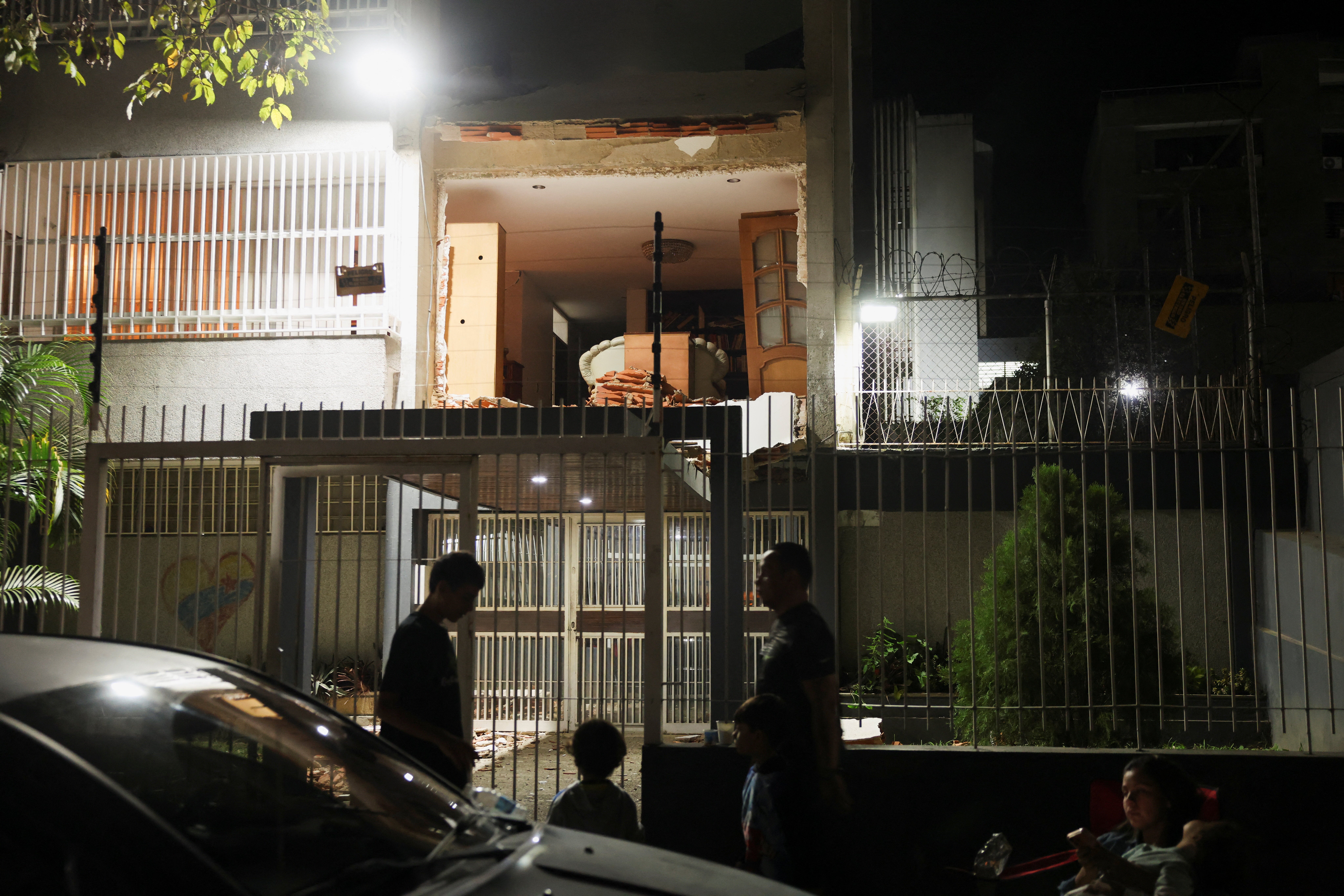 People gather outside a damaged building after an earthquake in Caracas, Venezuela, 24 June 2026