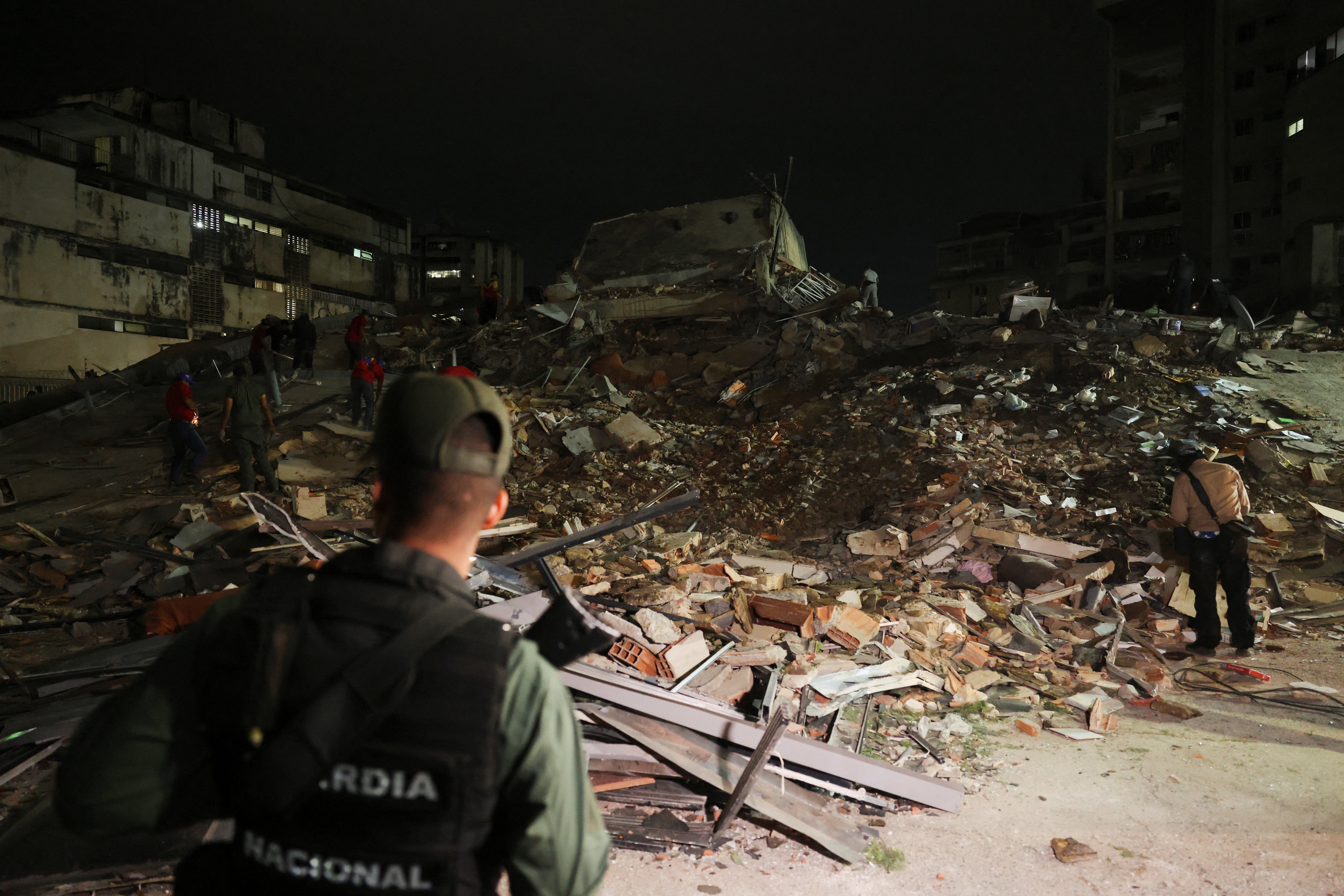 Emergency services work at the site of a collapsed building after an earthquake in Caracas, Venezuela, 24 June 2026 (Reuters)