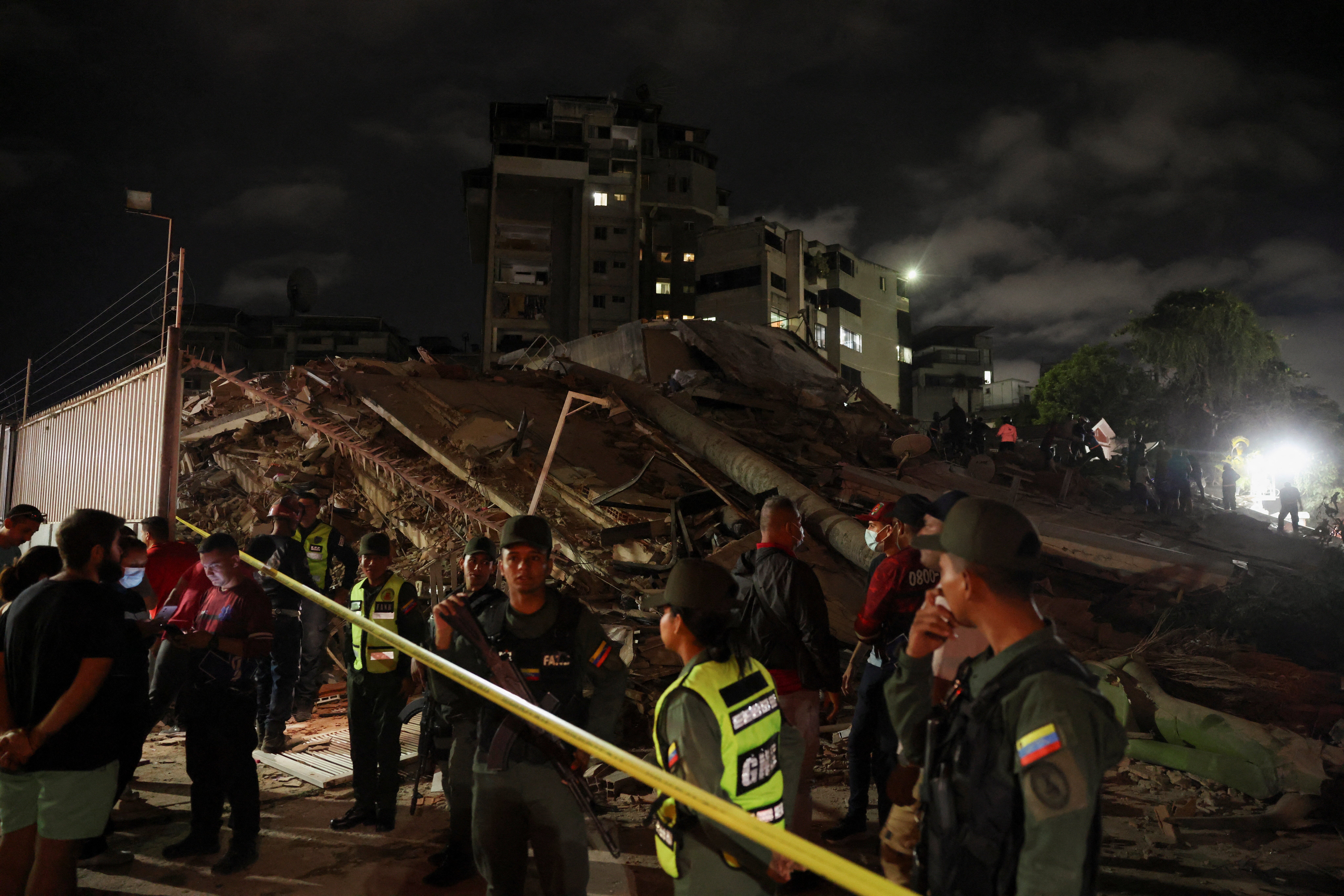 Members of the Bolivarian National Guard stand guard at the site of a collapsed building, which has been sealed off, after an earthquake in Caracas, Venezuela, 24 June 2026