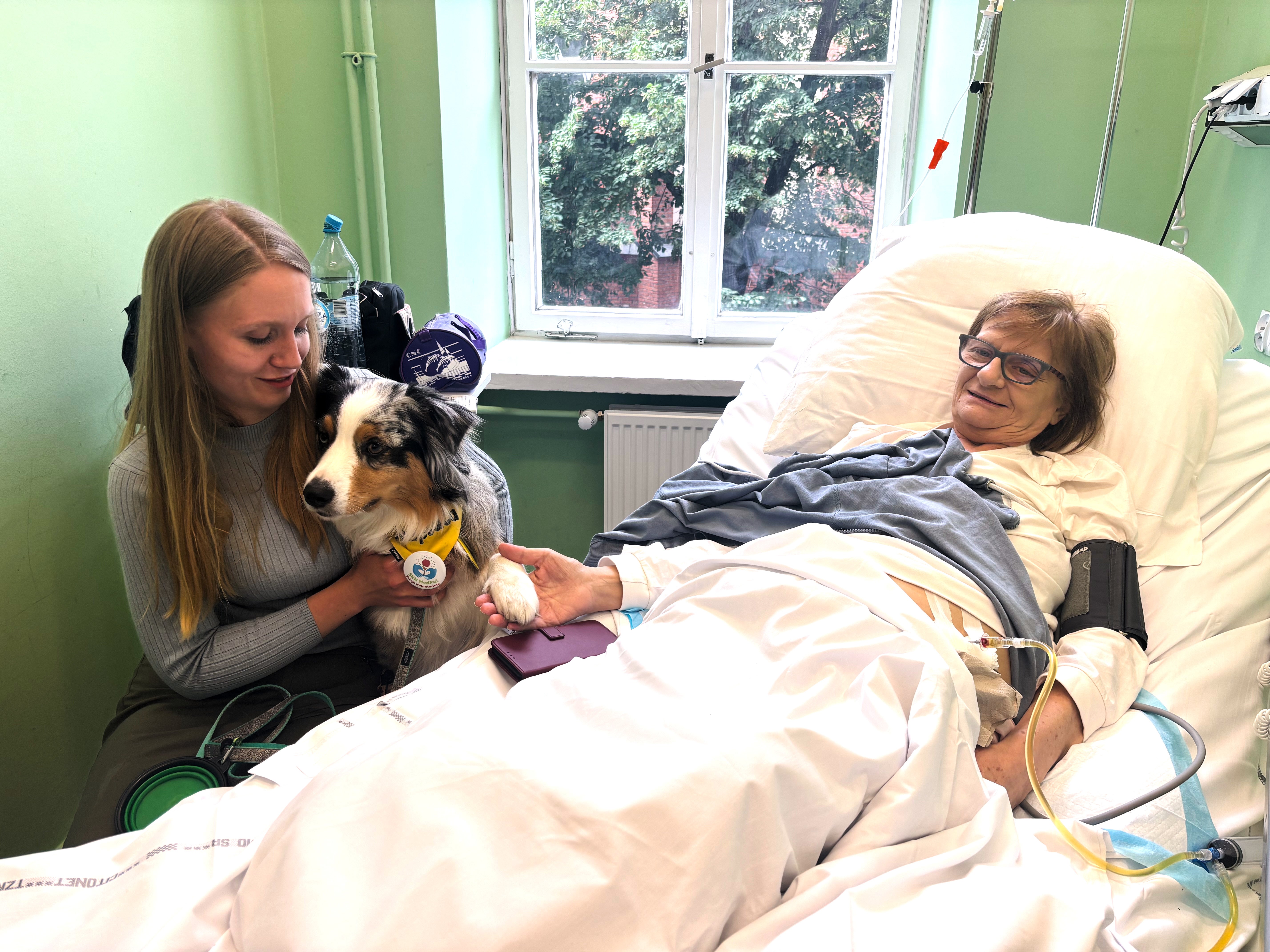 Medical student Malgorzata Brzozowska and her therapy dog Kluska visit the bedside of patient Ewa Lutka-Krawczyk at the Palliative Medicine Clinic at the Medical University of Warsaw, Poland, Monday, June 15, 2026. (AP Photo/Vanessa Gera)
