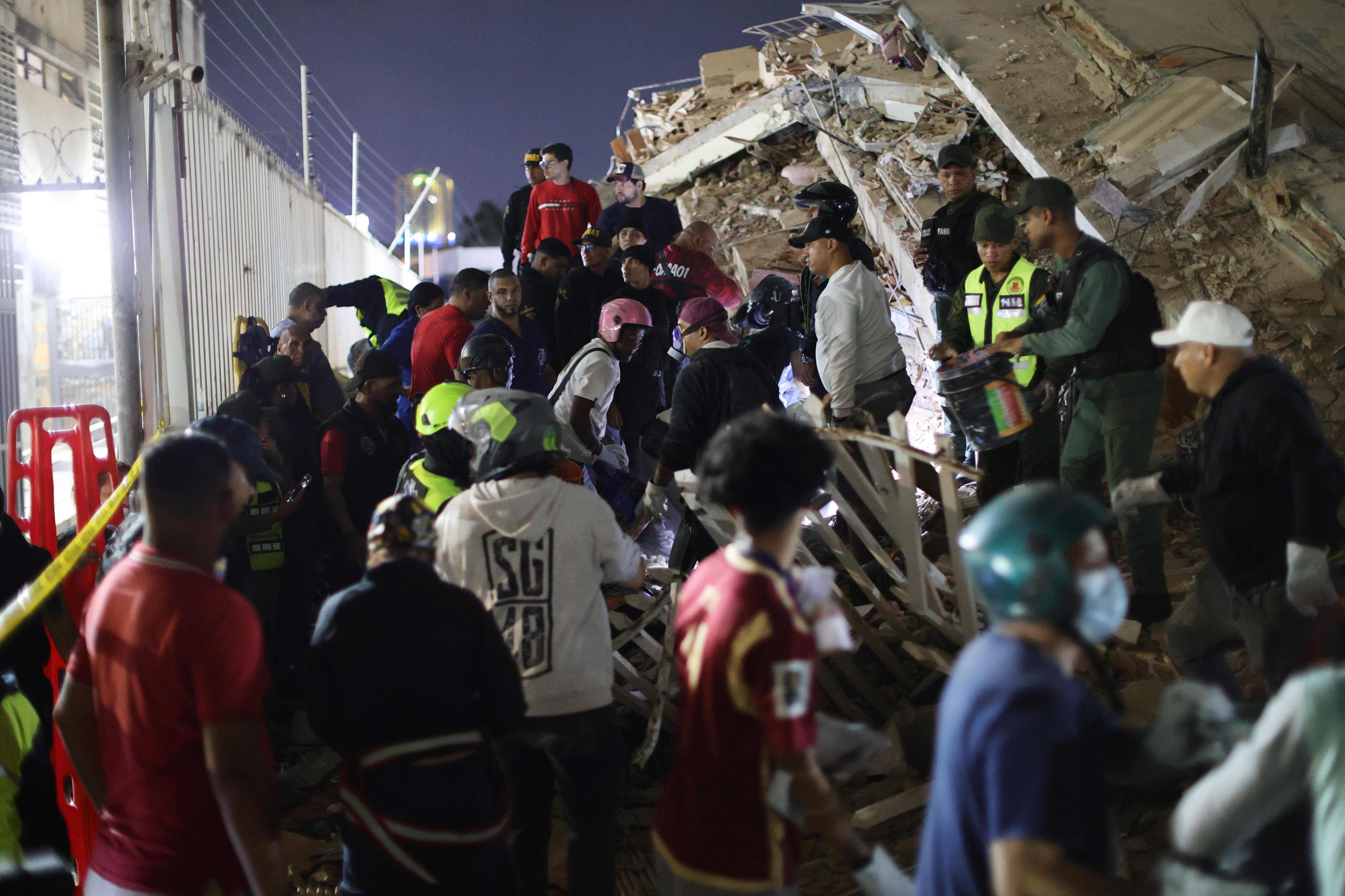 Responders search for victims in a demolished building in San Bernardino (Getty)