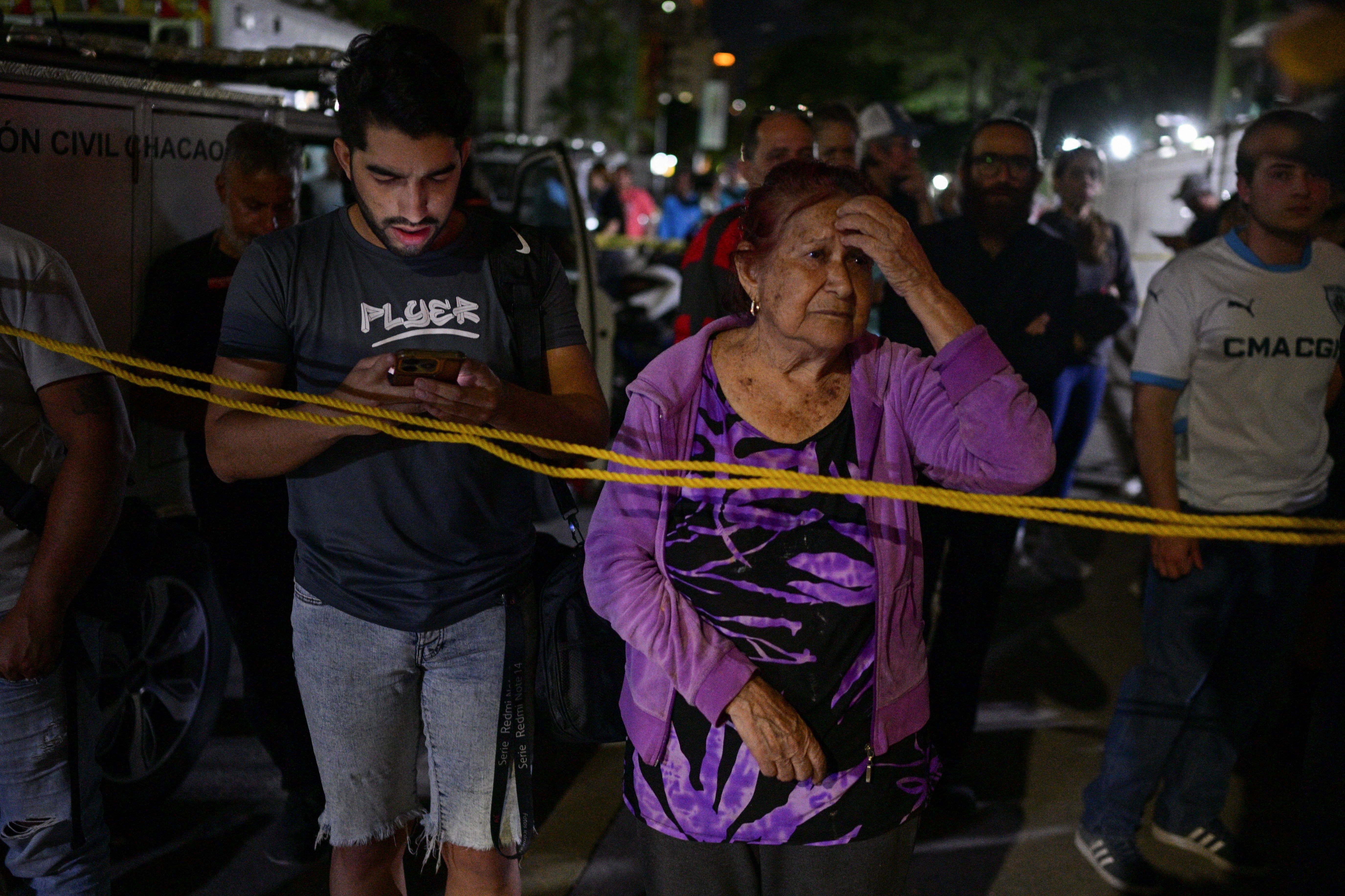 People stand at the site of a collapsed building, after an earthquake, in Caracas, Venezuela, June 25, 2026. (Reuters)