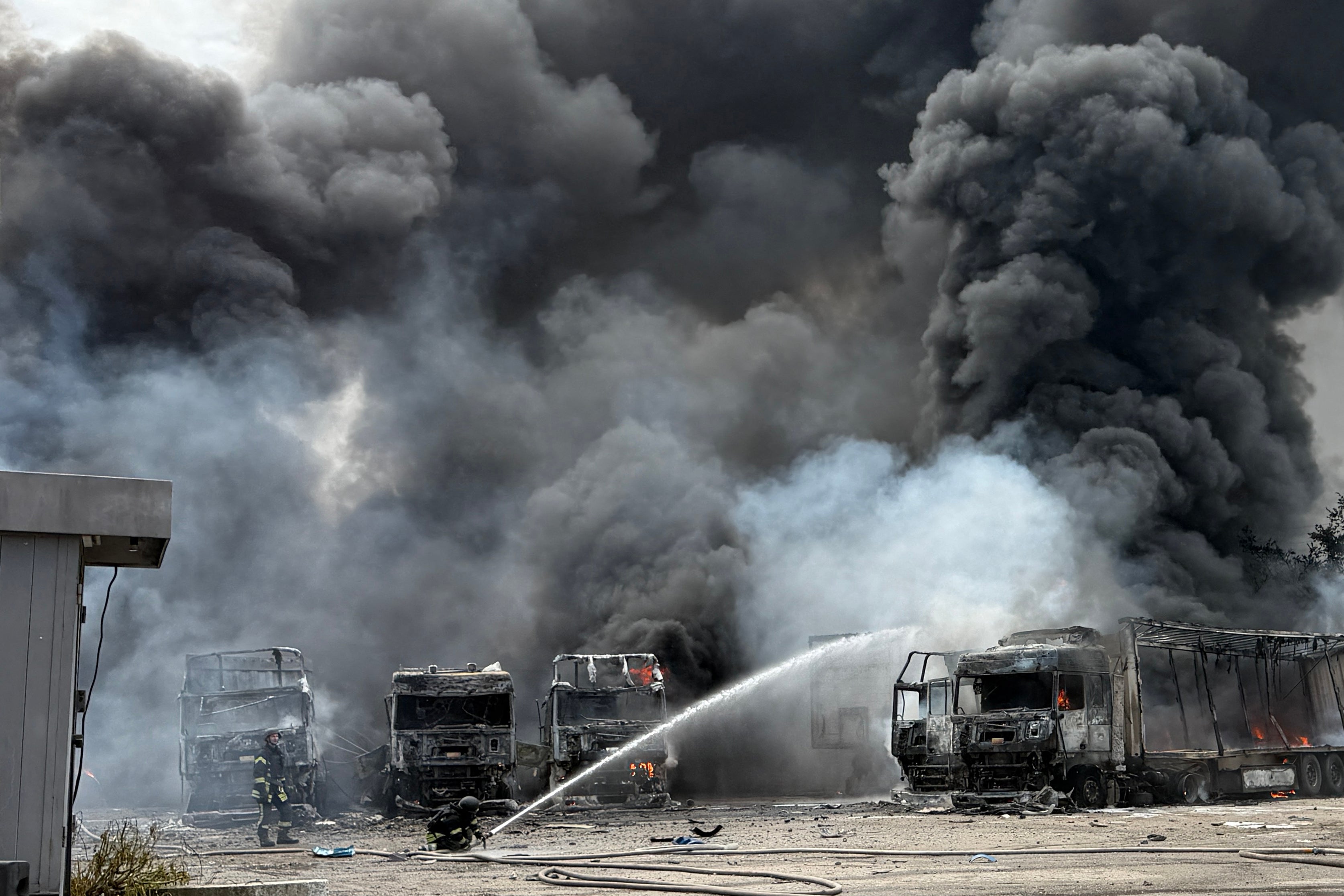 Ukrainian rescuers work to extinguish a fire at the site of an air attack in Zaporizhzhia on June 25 (AFP/Getty)