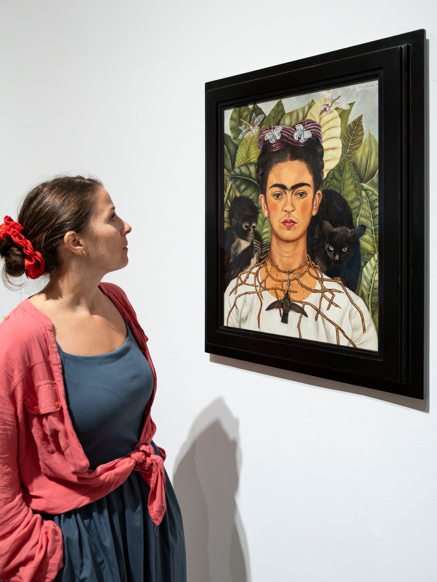 A visitor studies one of Kahlo’s self-portraits at Tate Modern’s ‘Frida: The Making of an Icon’ (Tate/Larina Fernandes)
