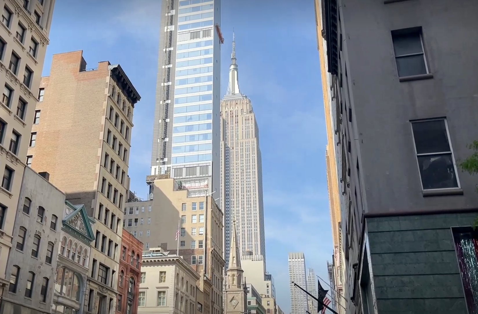 A close-up view of 262 Fifth Avenue and the Empire State Building from Fifth Avenue shows the scale of the luxury apartment building