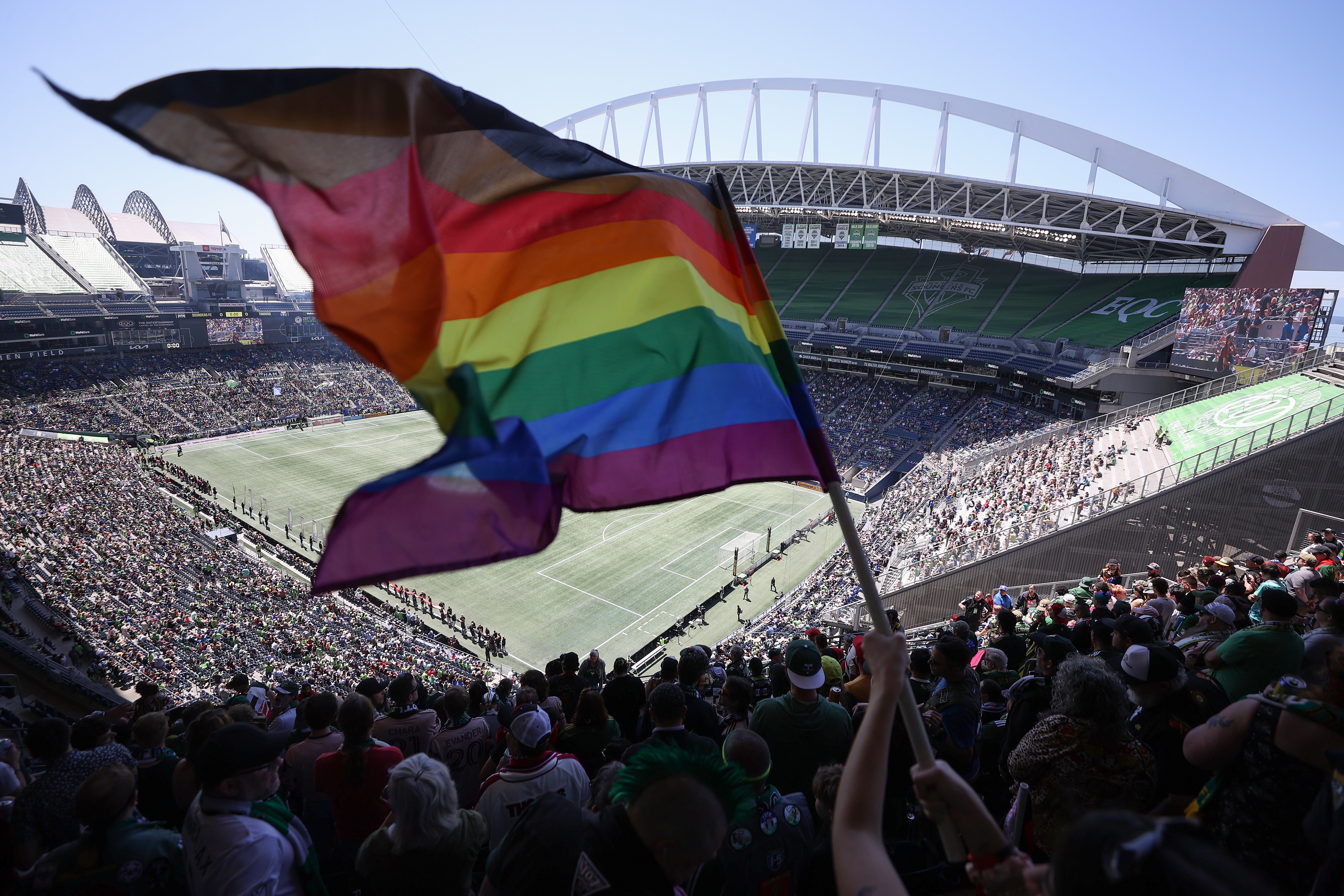 A fan waves a Pride flag before the game between the Seattle Sounders and the Portland Timbers at Lumen Field on June 03, 2023
