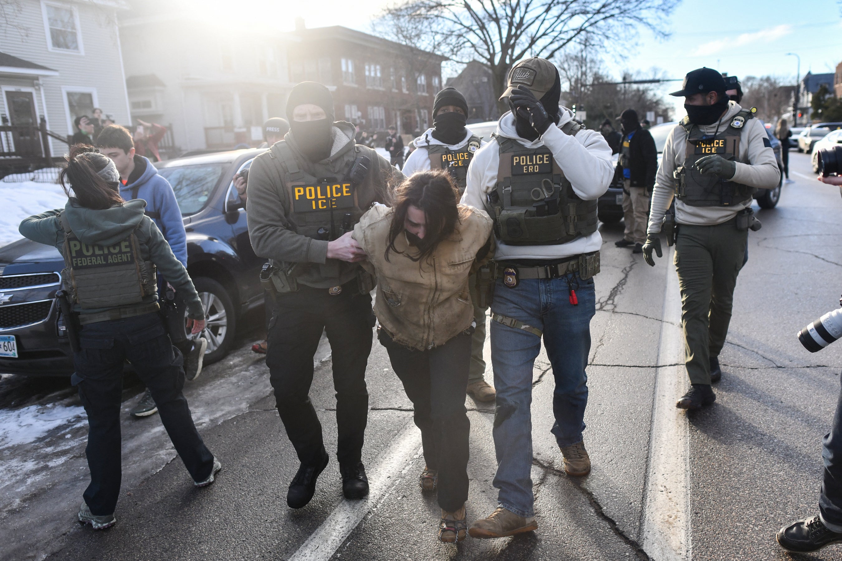 Fifty-two people have died in ICE custody since President Trump's return to office, according to a new report from Human Rights Watch. Pictured: federal officers detain a person during protests in Minneapolis, Minnesota, on January 13, 2026