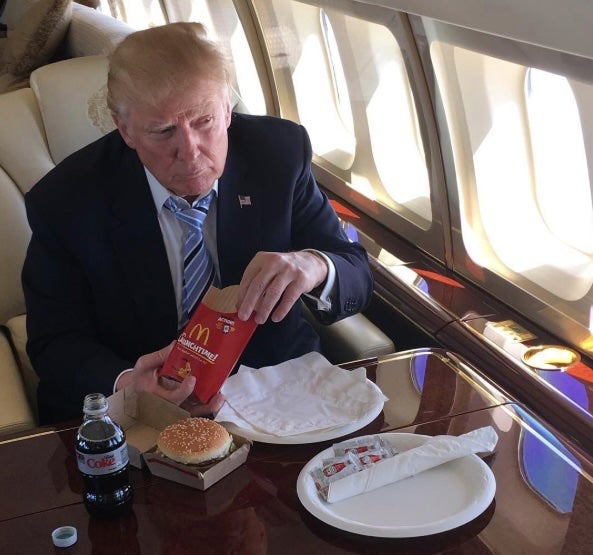 President Donald Trump eats McDonald's fries alongside a burger and a Diet Coke while sitting on Air Force One in May 2016 (@realdonaldtrump/Instagram)