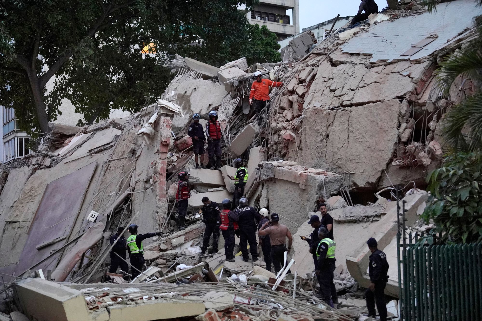 Rescuers search for victims in a collapsed building