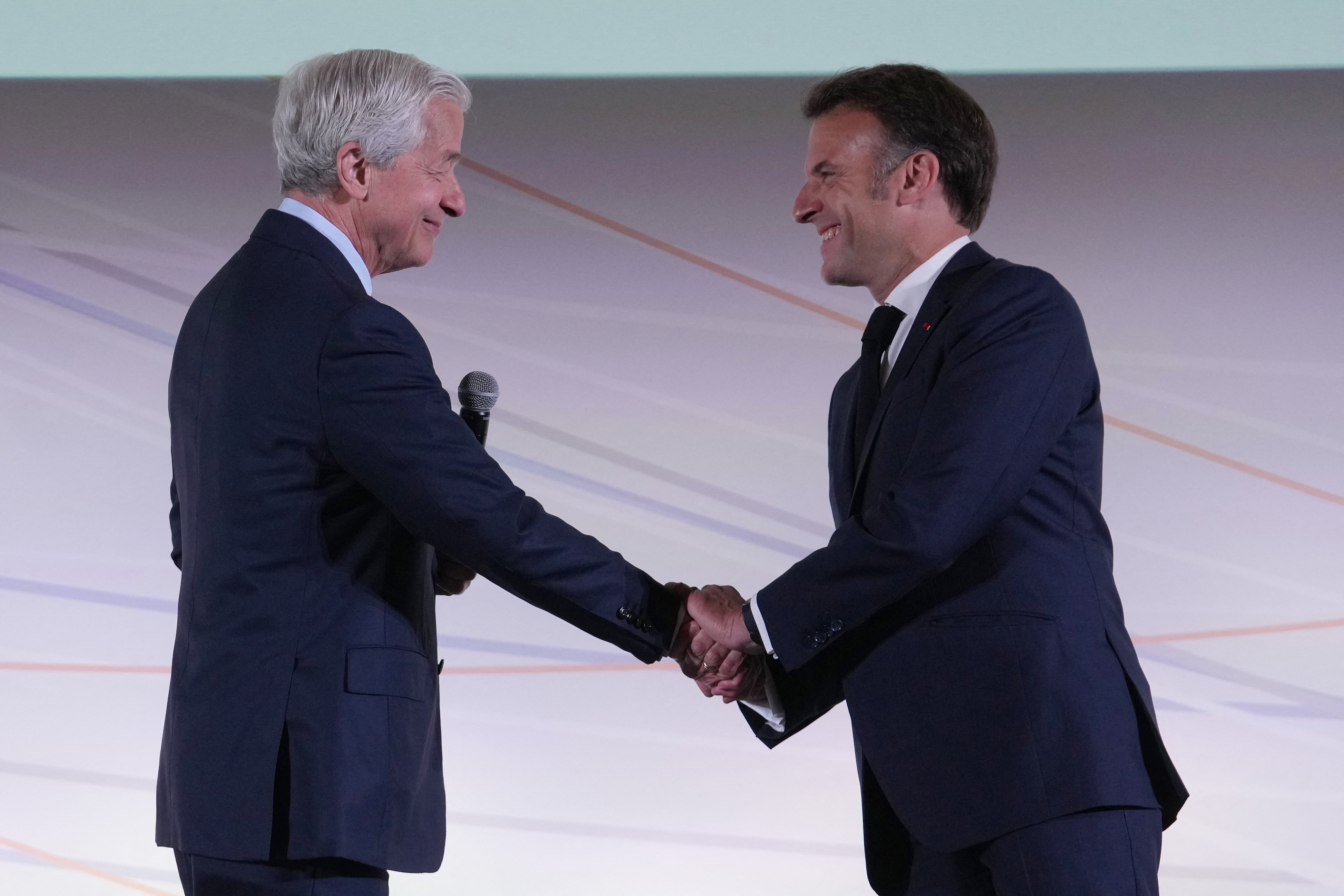 France's President Emmanuel Macron (R) shakes hands with JPMorgan Chase CEO Jamie Dimon during the Global Markets Conference, ahead of the Choose France summit, in Paris, on May 15, 2025