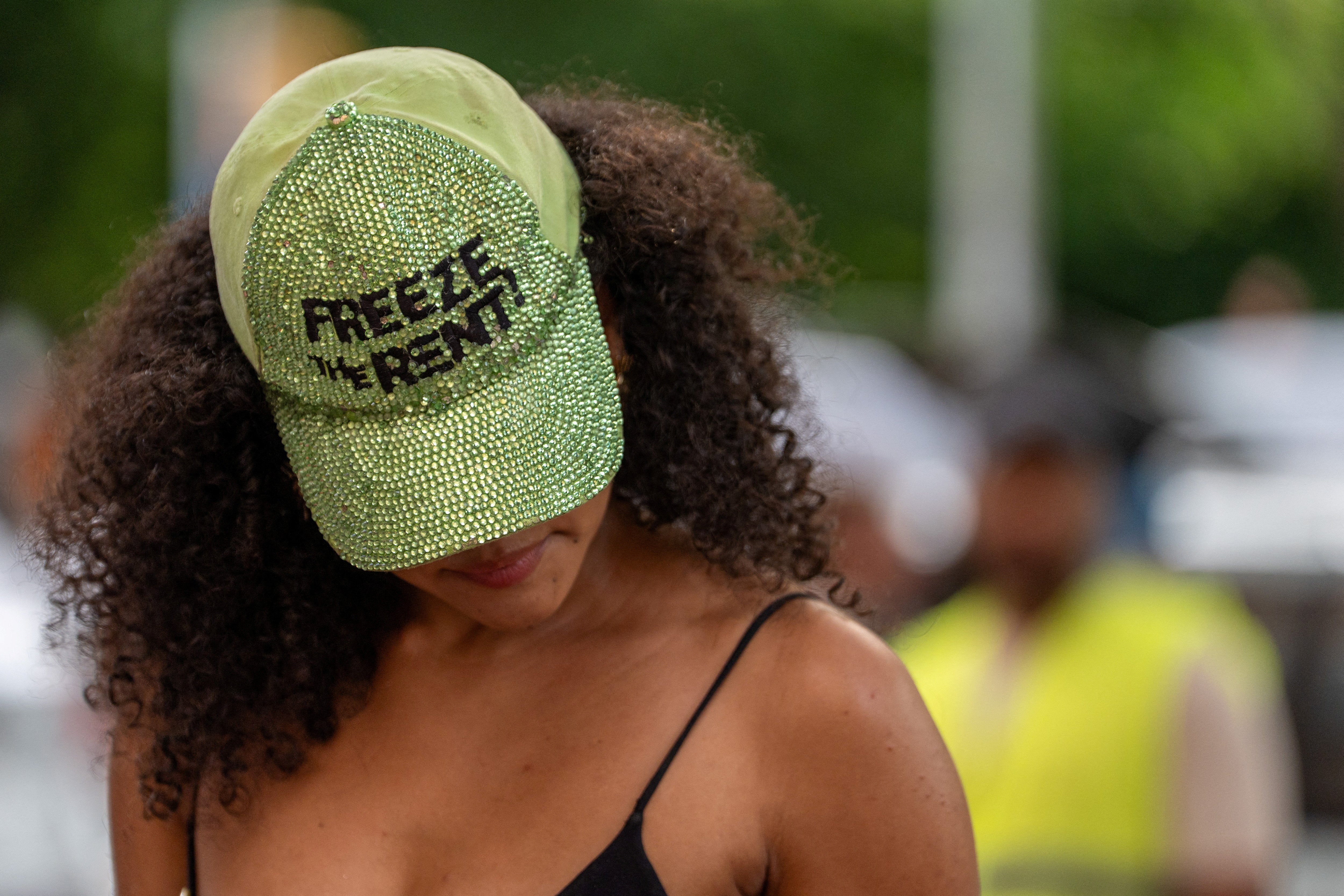 A person wears a hat that reads 